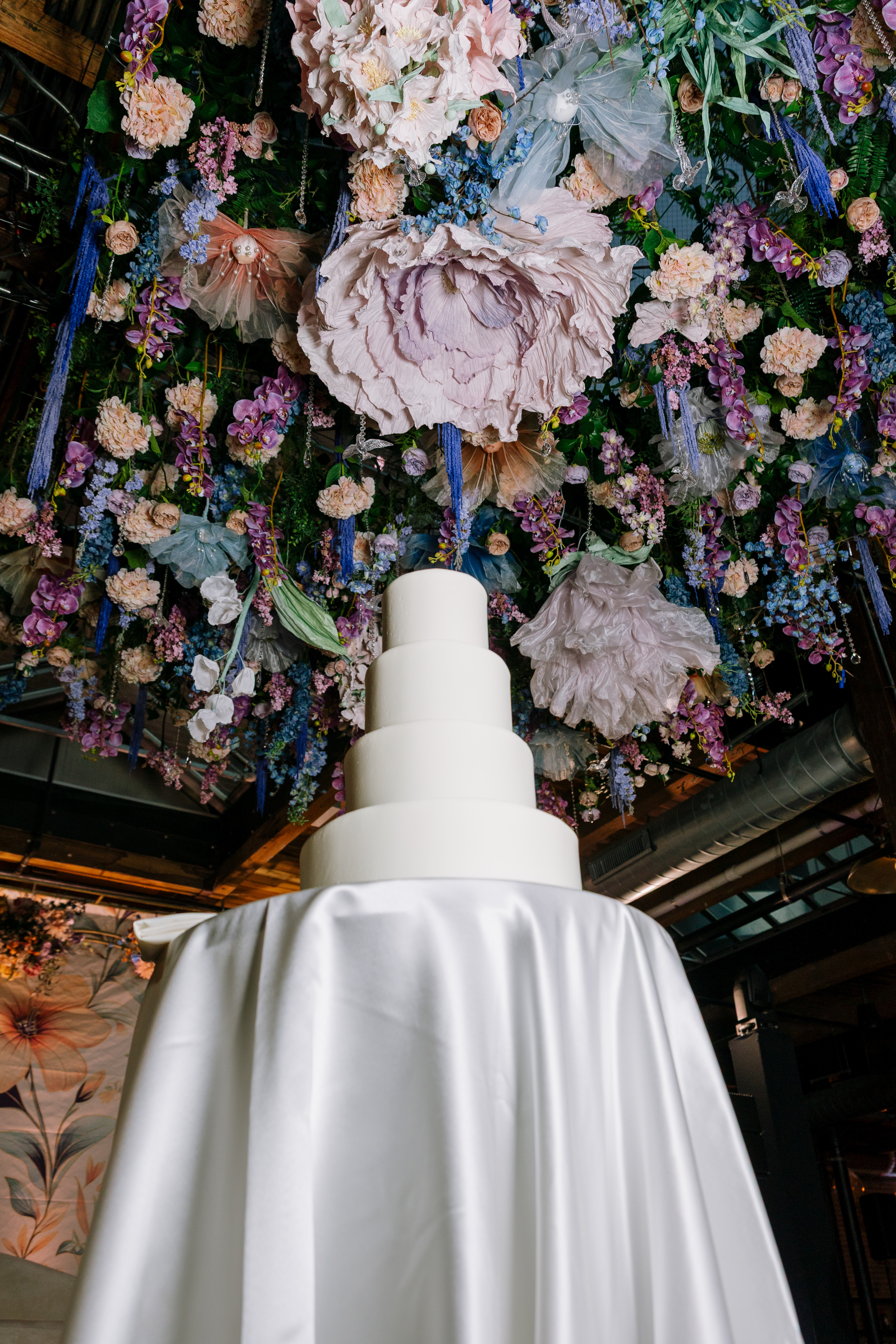 wedding cake under the reception floral decor ceiling-Lusia Studio Photography 