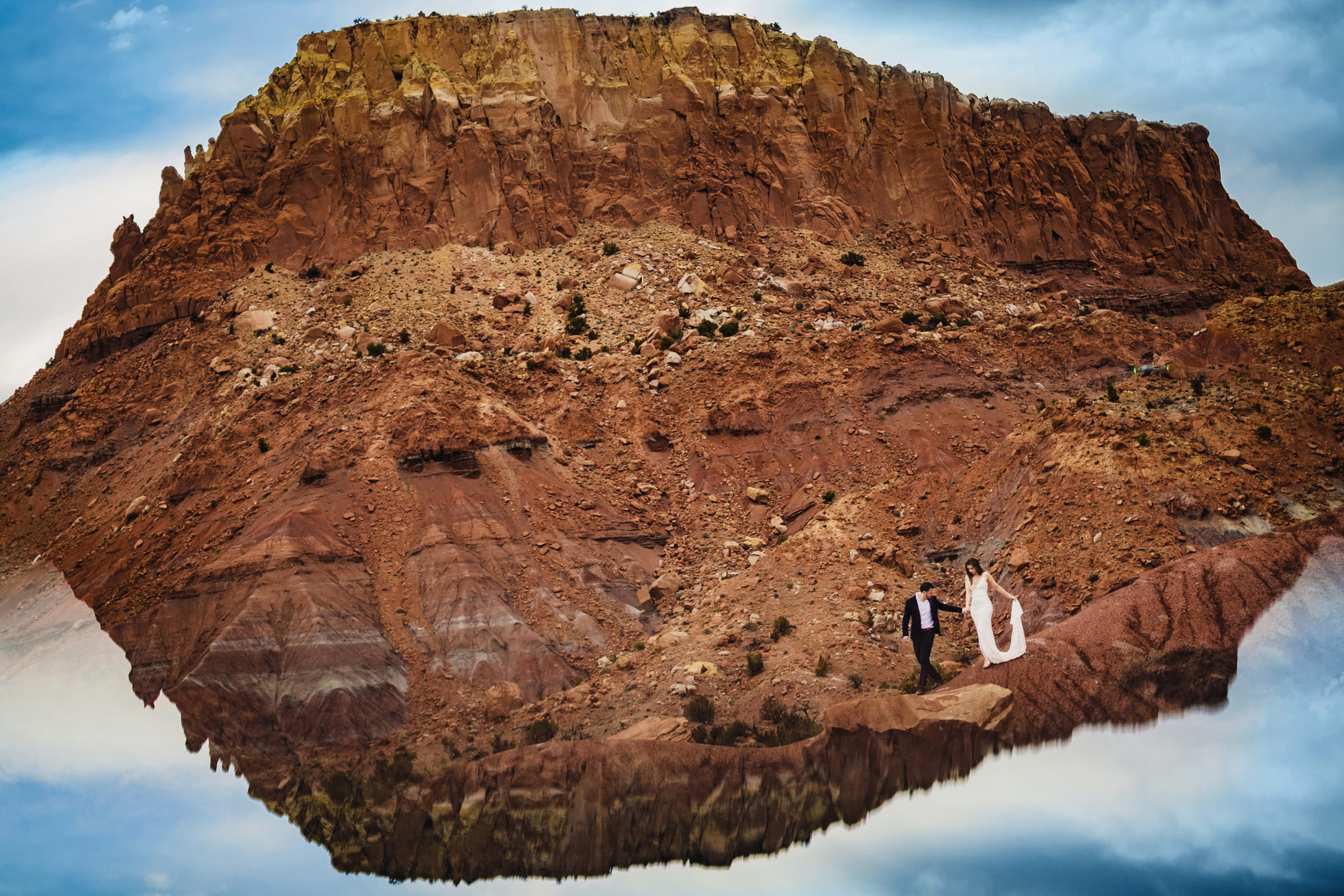 bride-and-groom-against-rocky-cliffs-reflection-photo-by-chrisman-studios