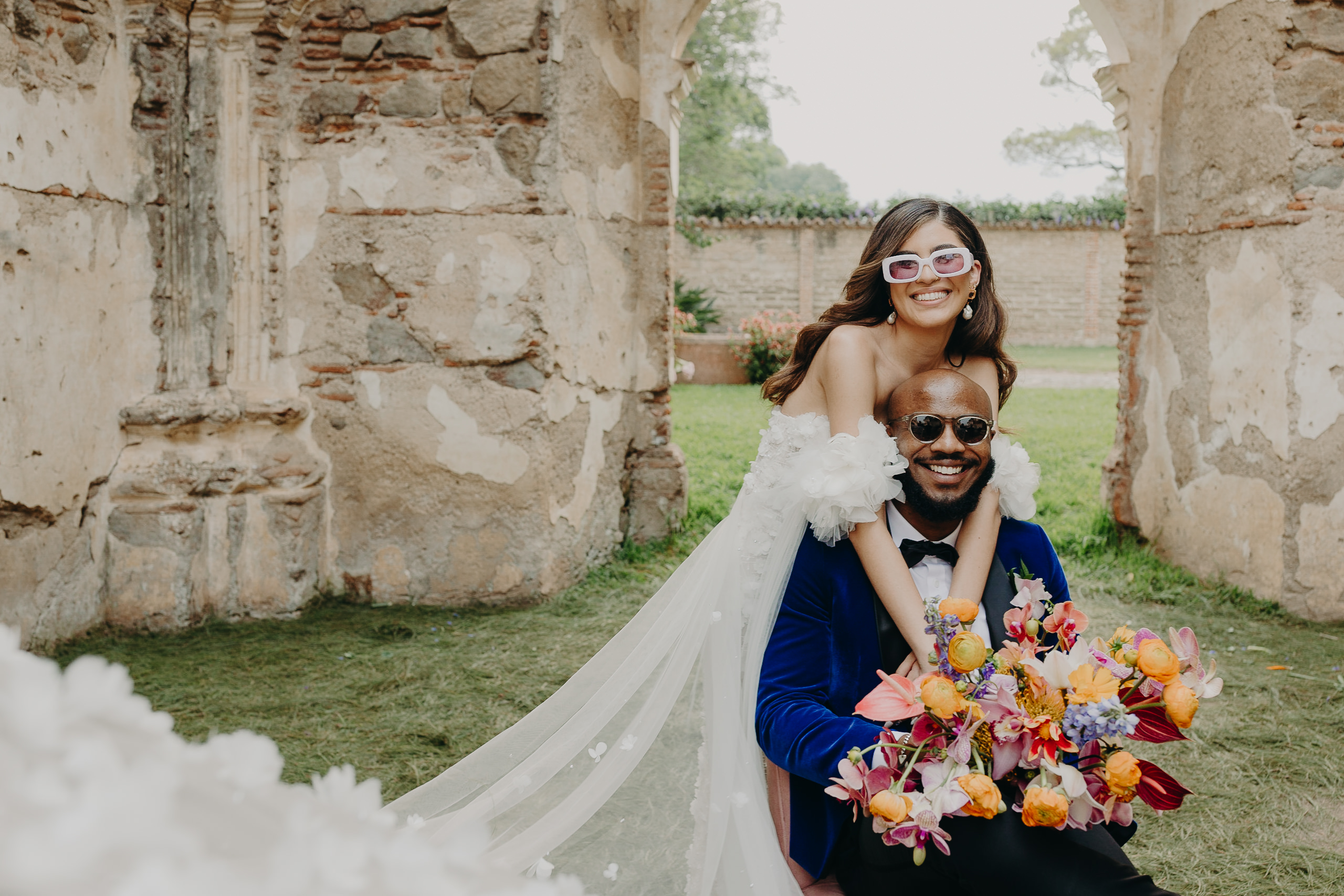 Fun couple portrait with glasses and bouquet