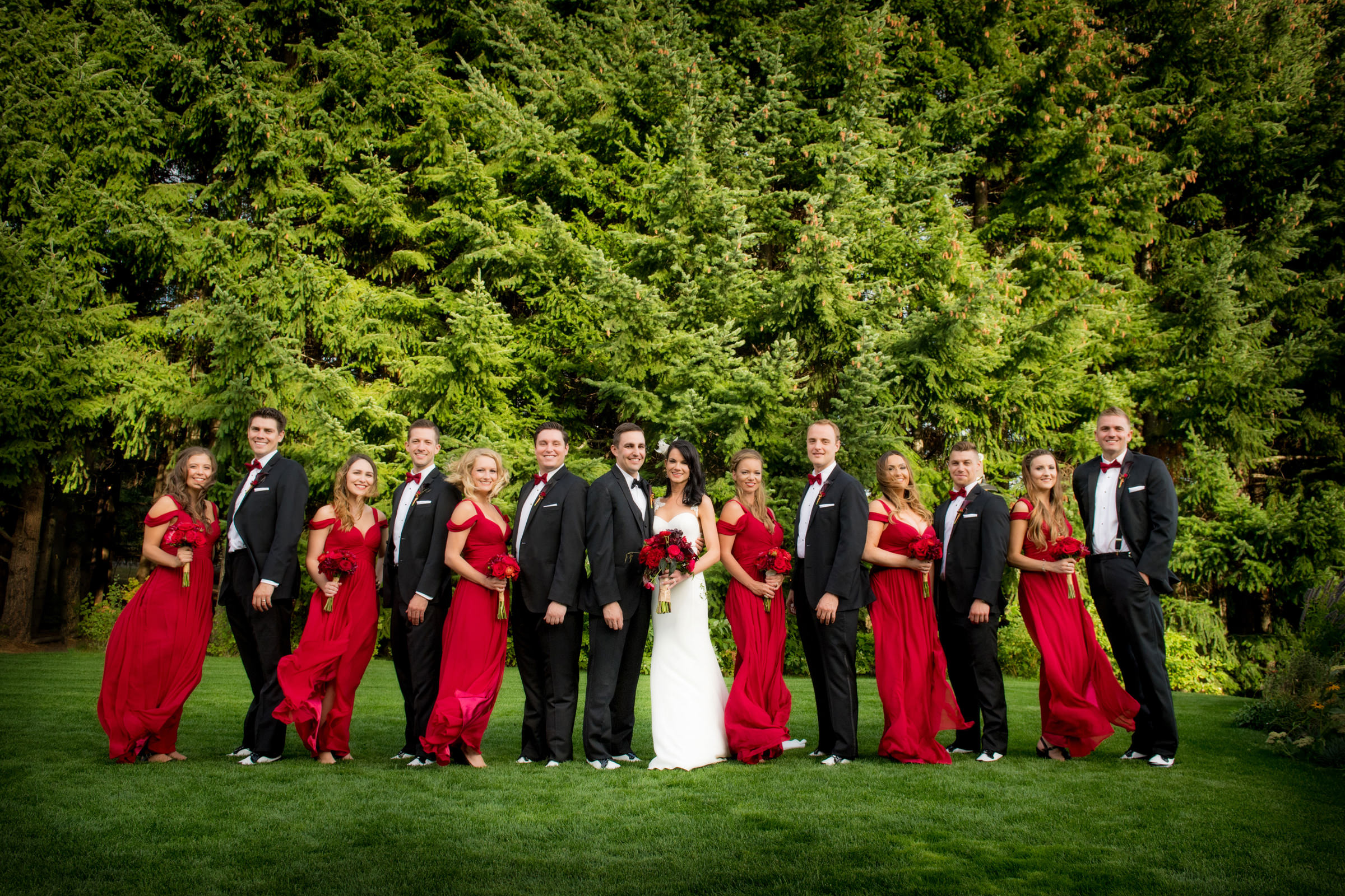 Wedding party with tuxedos and red gowns