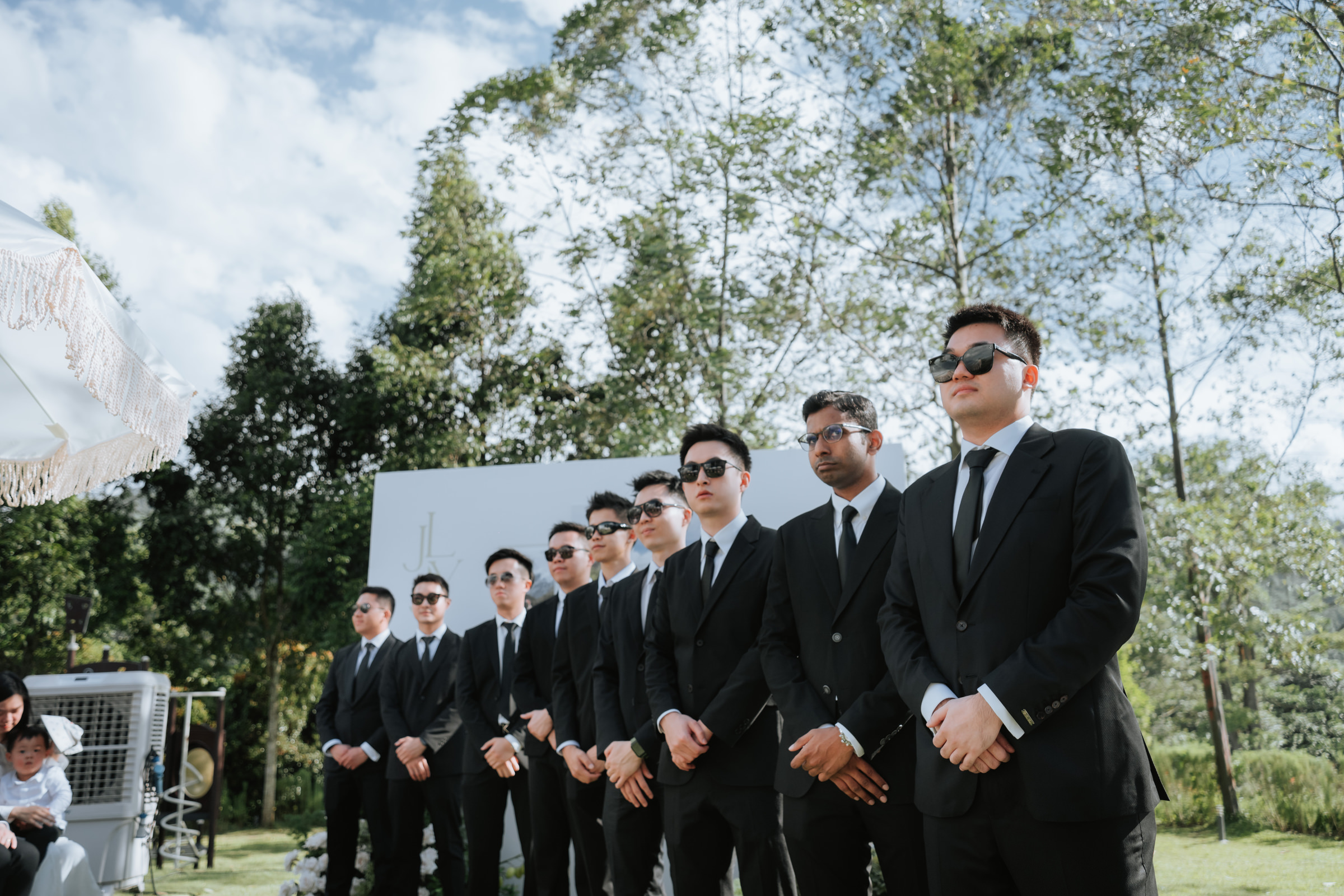 Groomsmen line up during wedding at Acres Resort photographed by Zach Chin