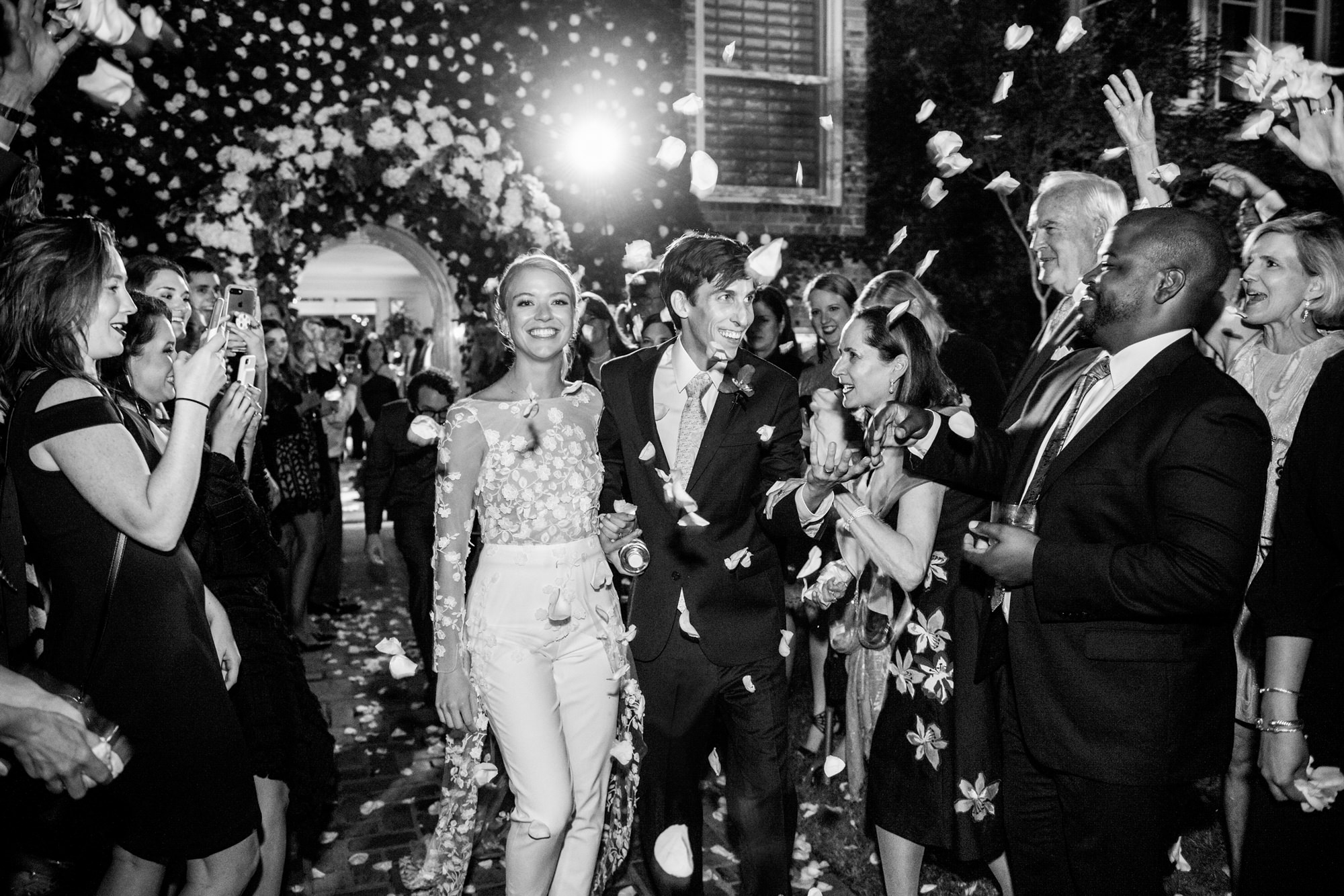 fashionable-couple-exits-reception-as-guests-throw-flowers-worlds-best-wedding-photos-morgan-lynn-razi-texas-wedding-photographers