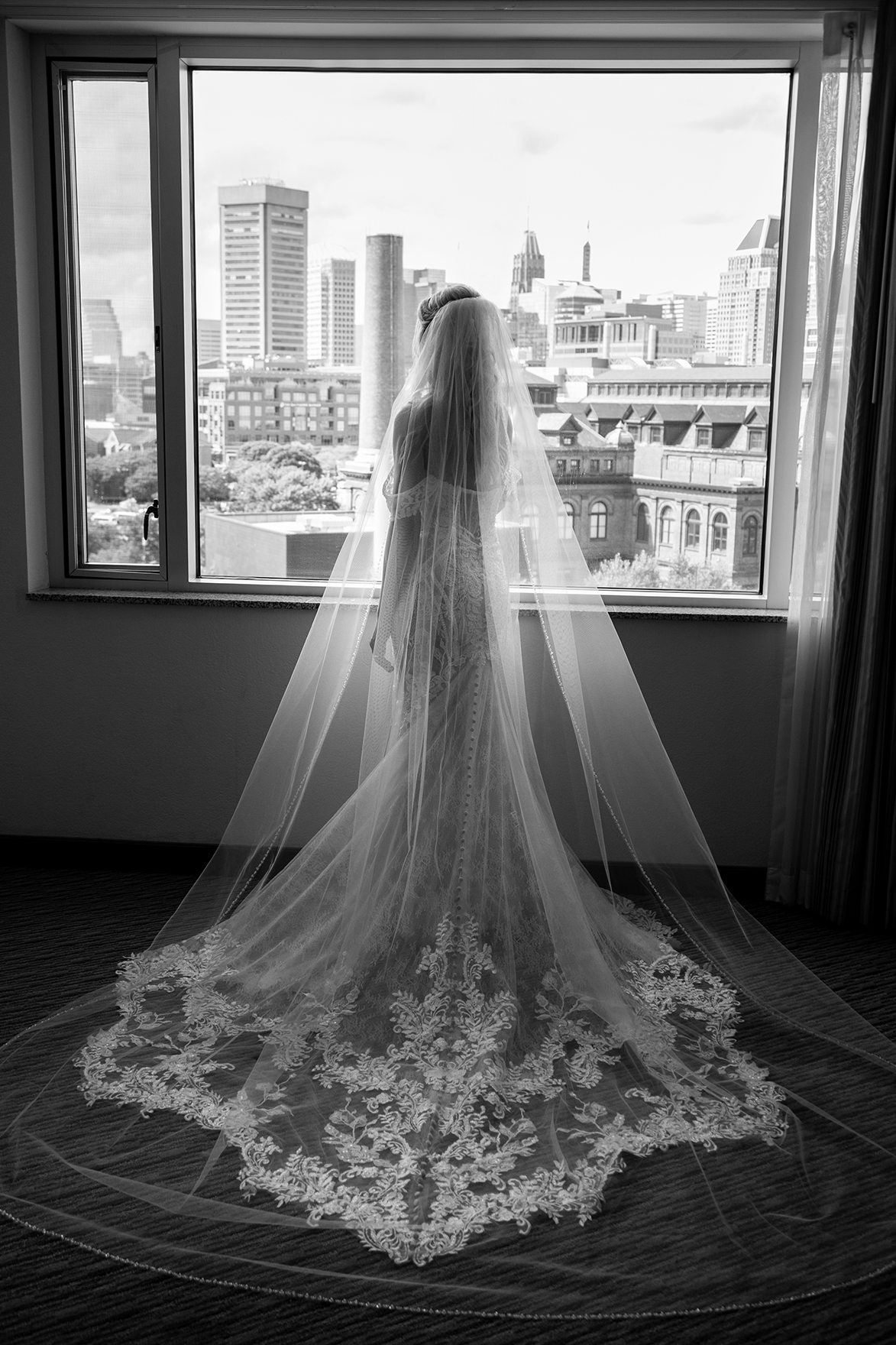Back view of bride at window cityscape Anna Schmidt Photography 