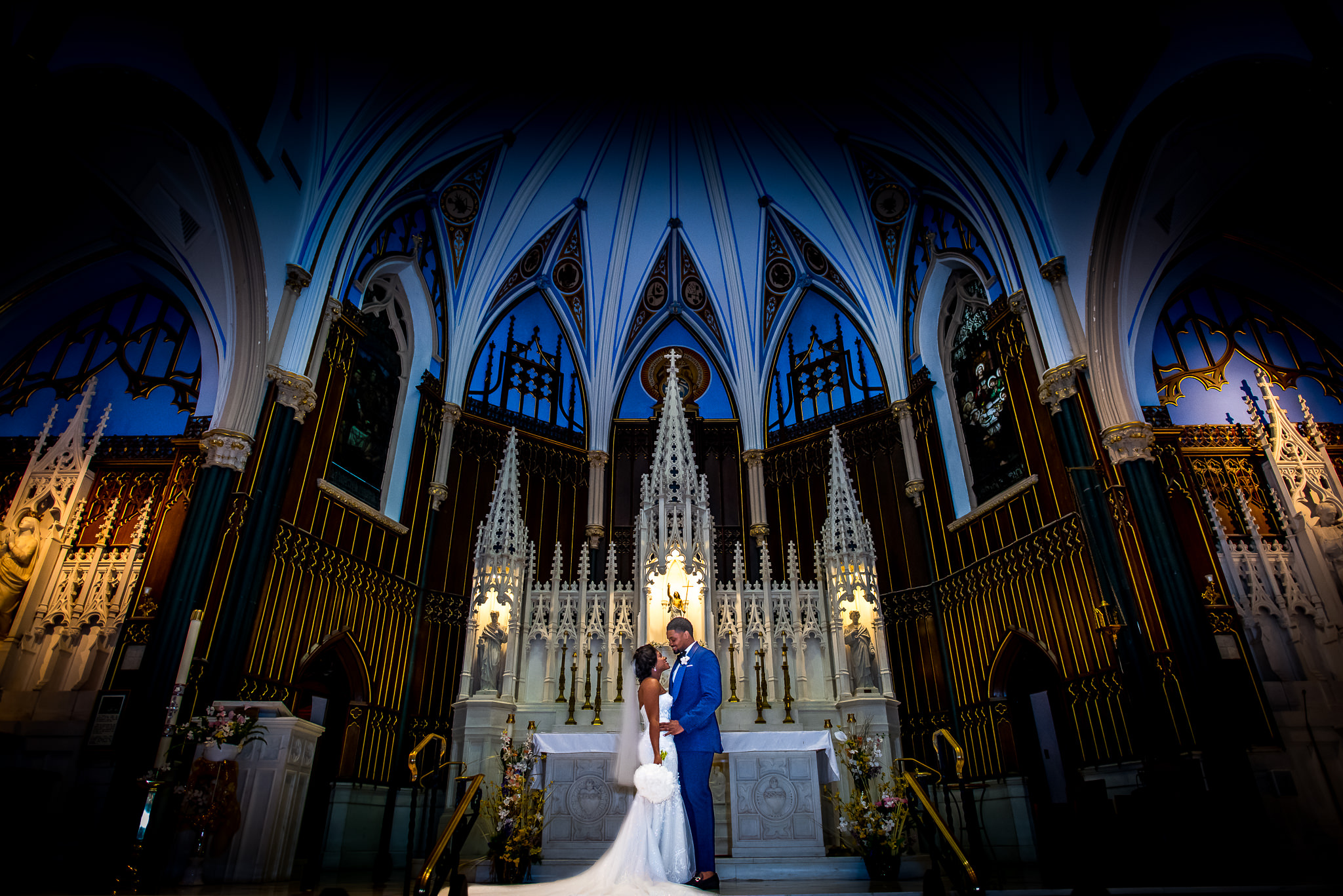 Bride and groom pose in cathedral Adibe Photography