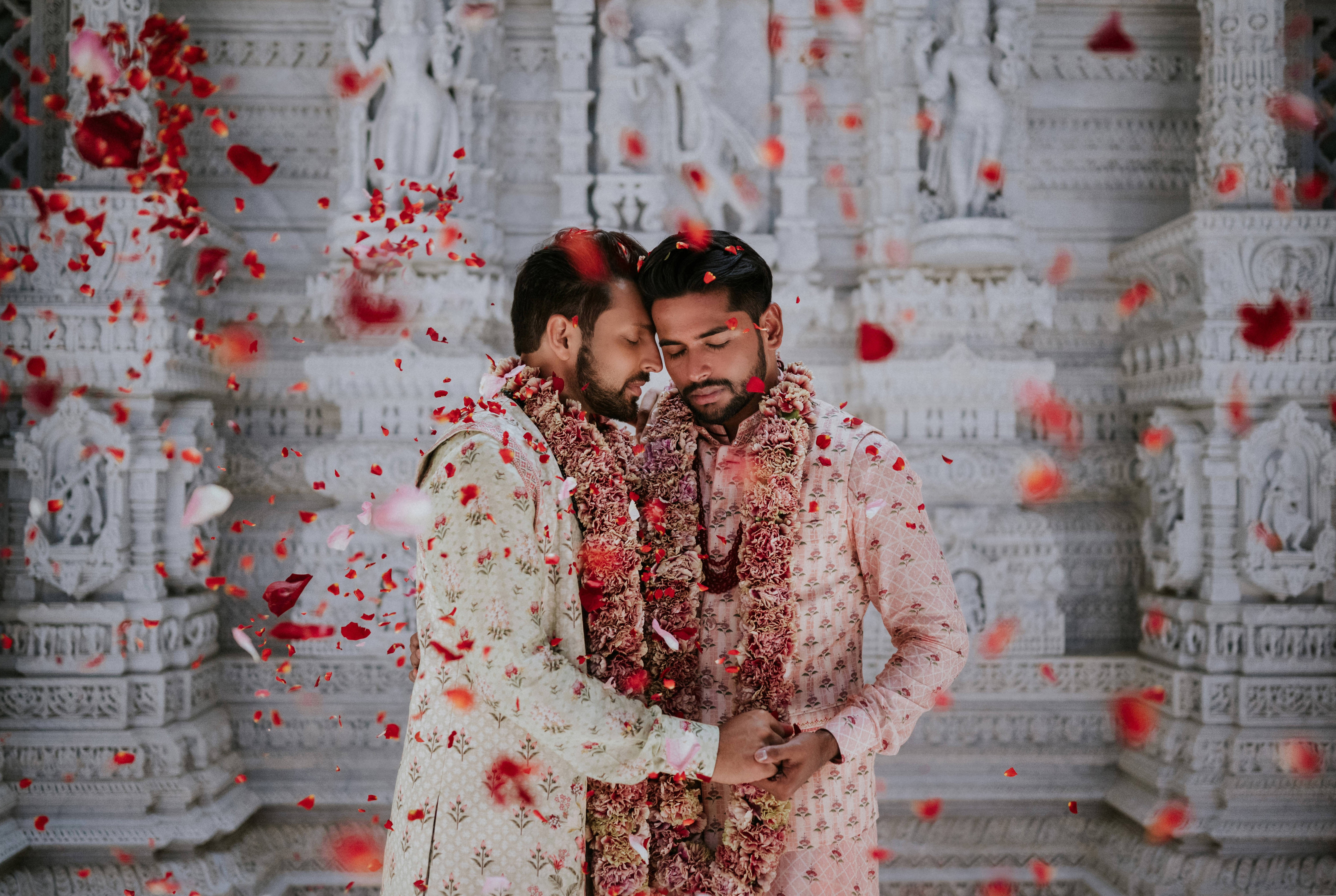 two-grooms-under-shower-of-rose-petals-charmi-pena