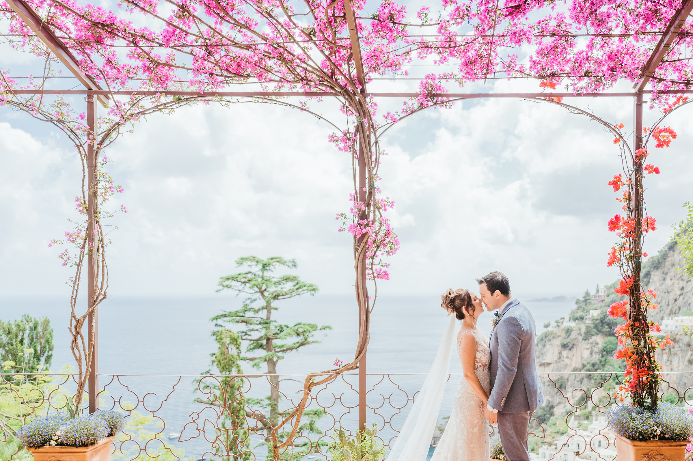couple-portrait-under-floral-trellis-at-amalfi-coast-waterfront-photo-by-emiliano-russo-photography