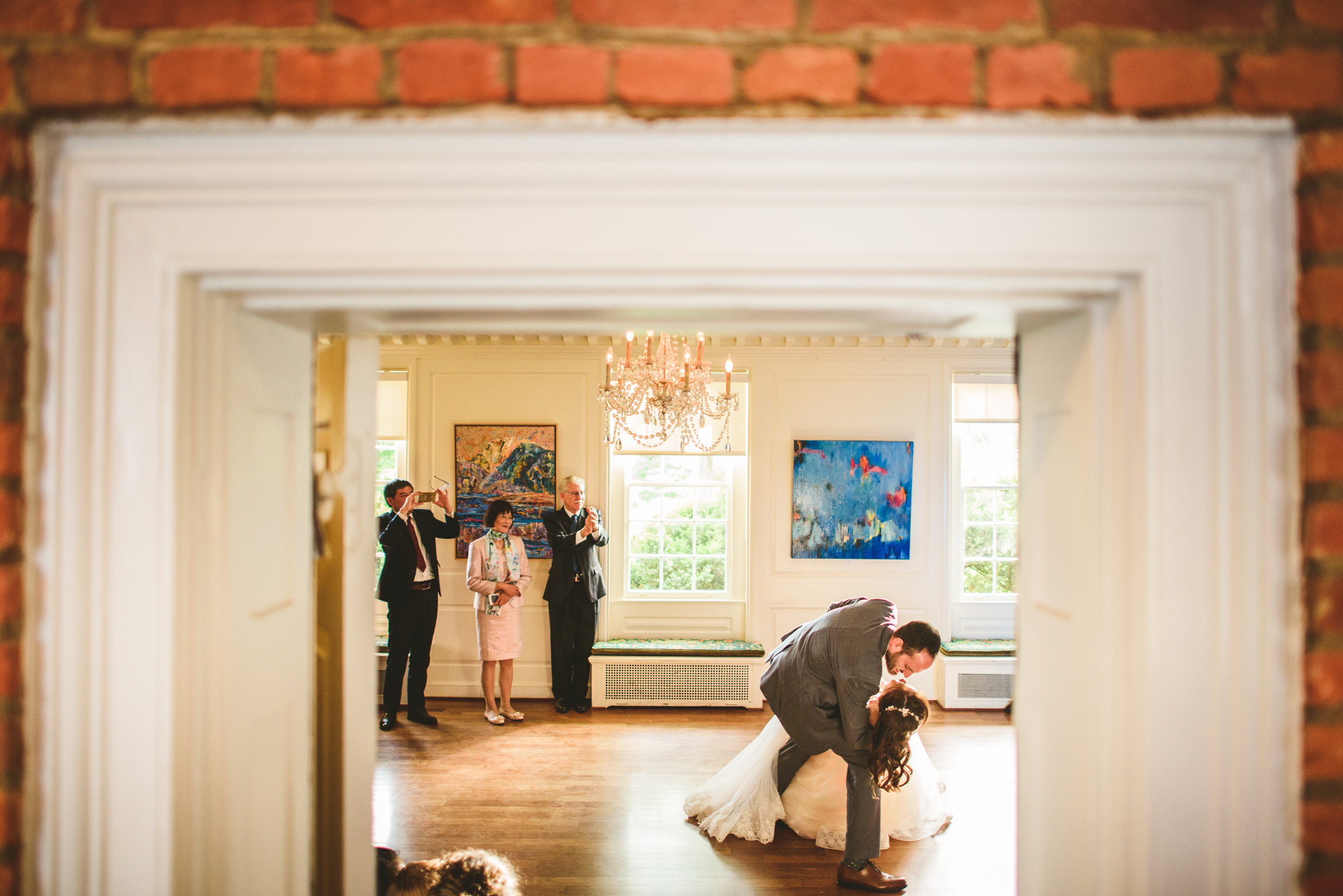Groom tips back bride to floor Sam Hurd Photography
