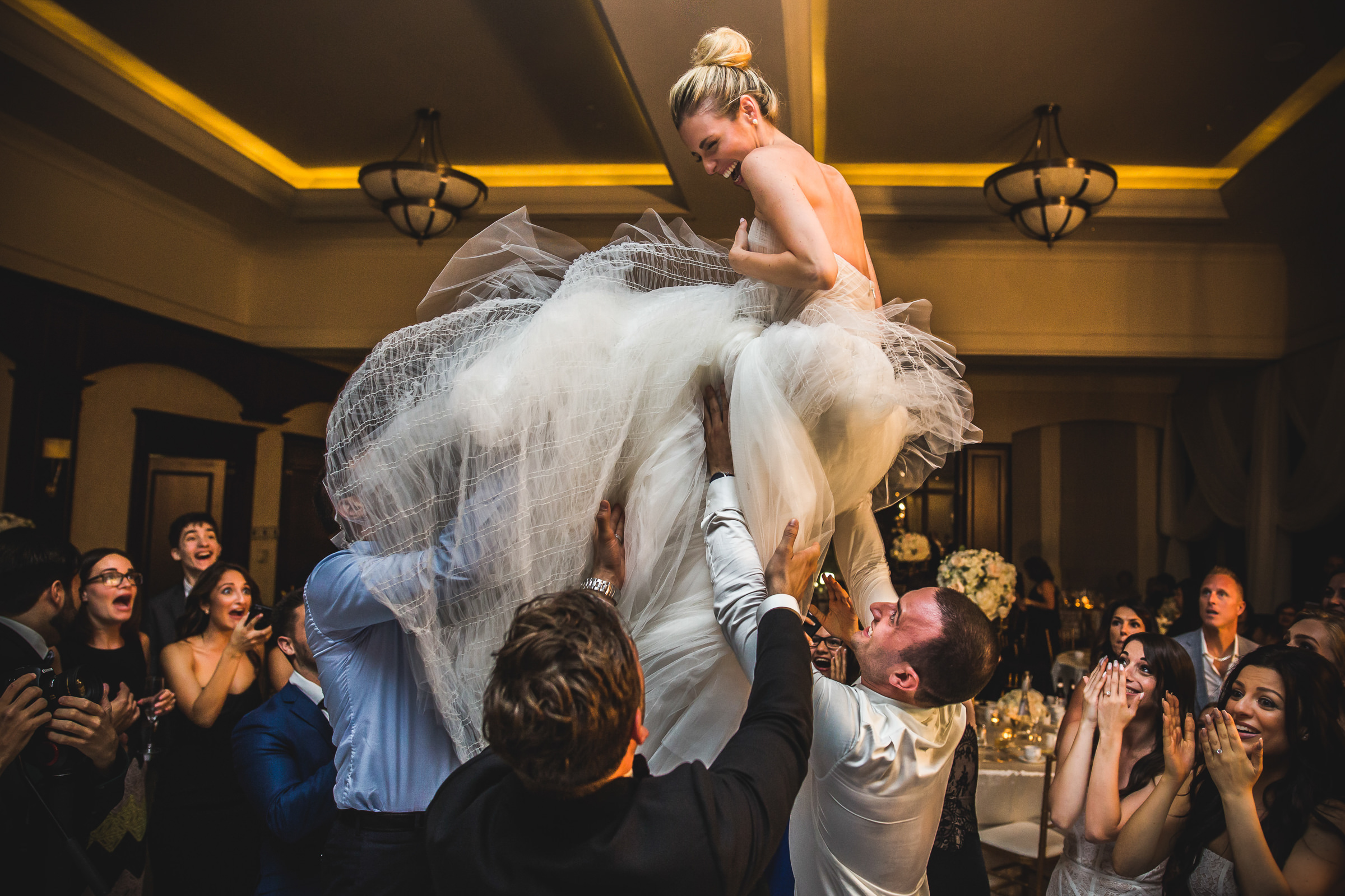 Bride being tossed in the air at reception by Marlies Hartmann of Los Angeles