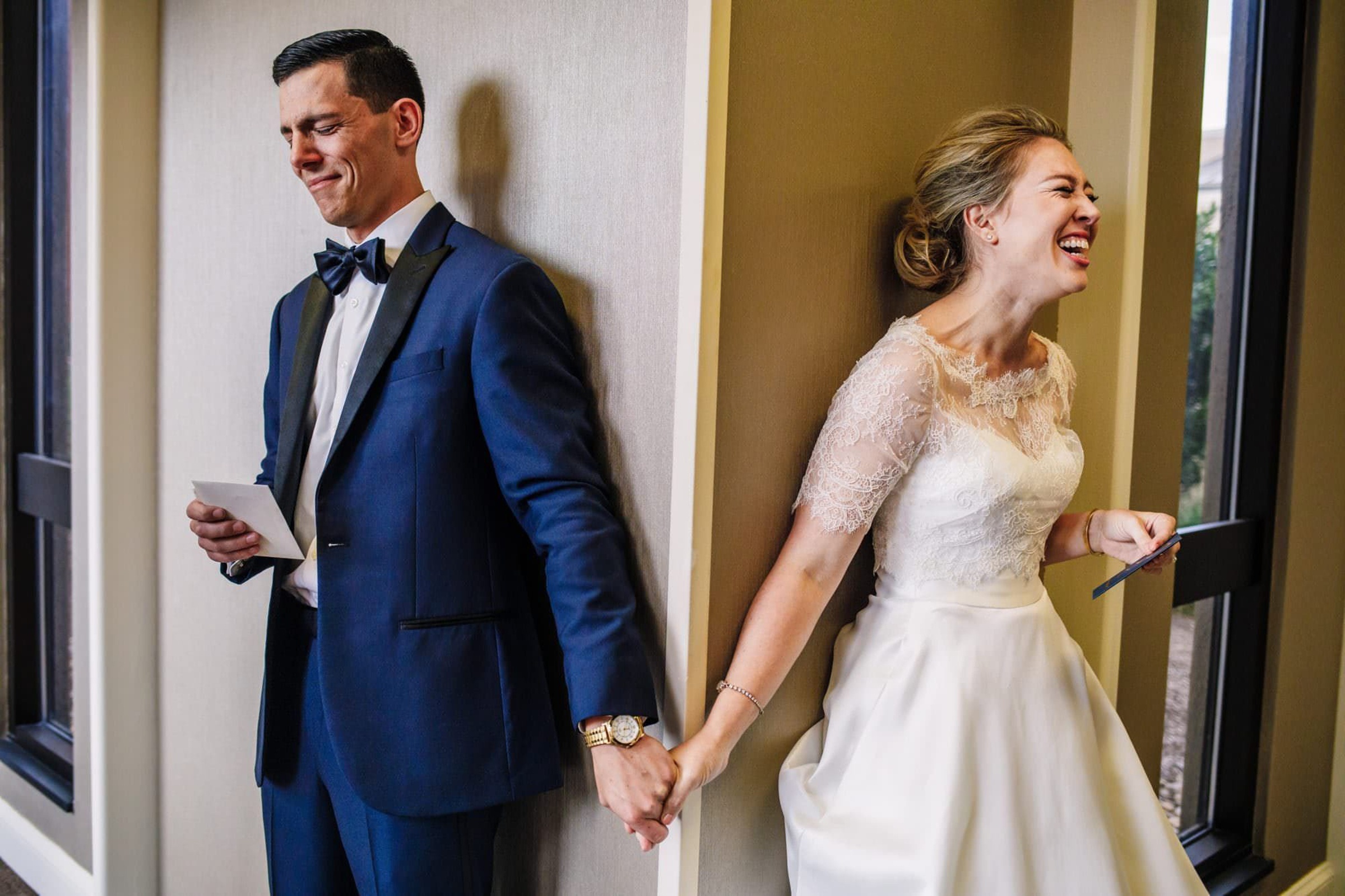 Bride and groom holding hands during first look Photography by Brea