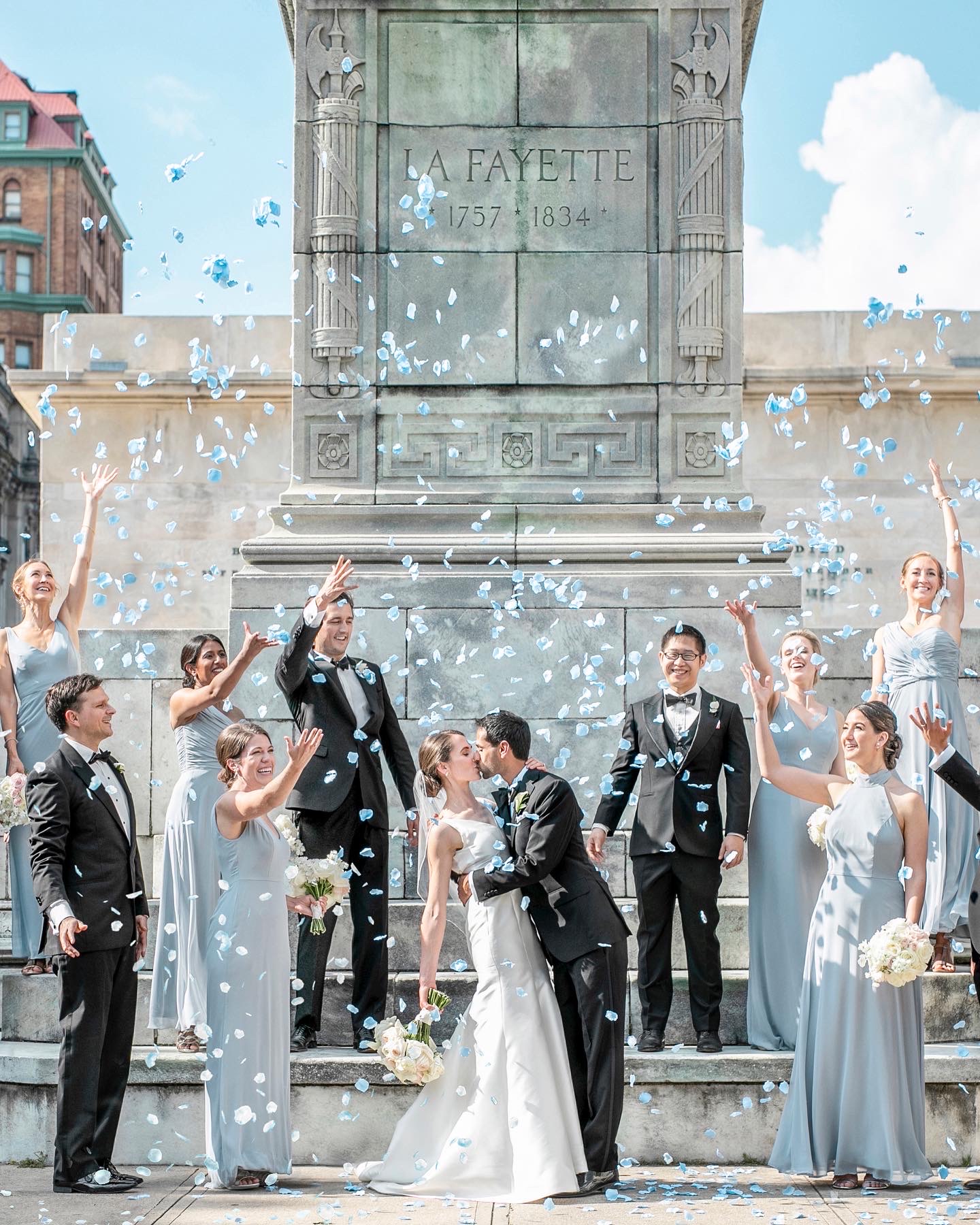 Group shot with staged kiss against Lafayette grave Anna Schmidt Photography 