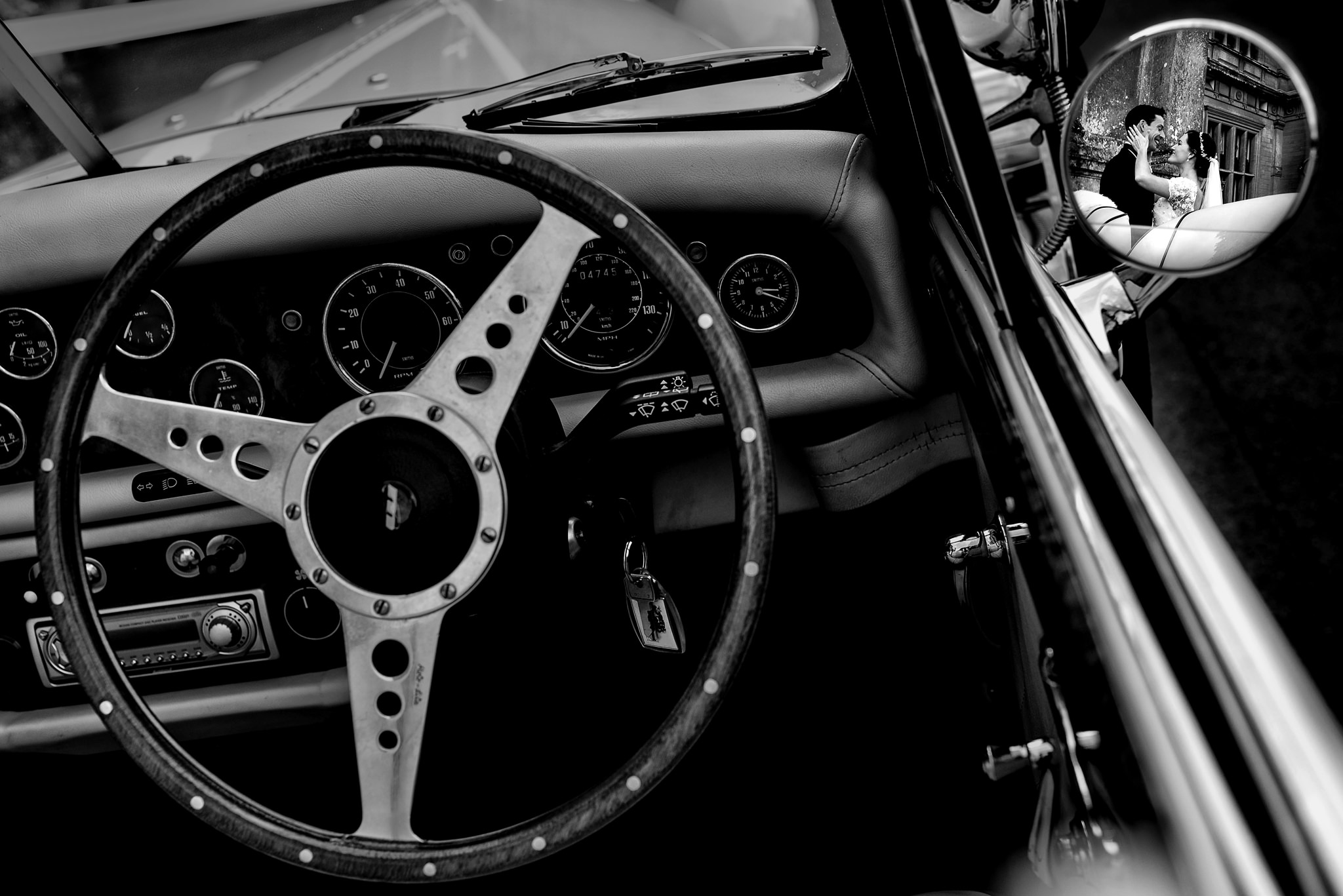 bride-and-groom-reflected-in-mirror-of-antique-car-rich-howman
