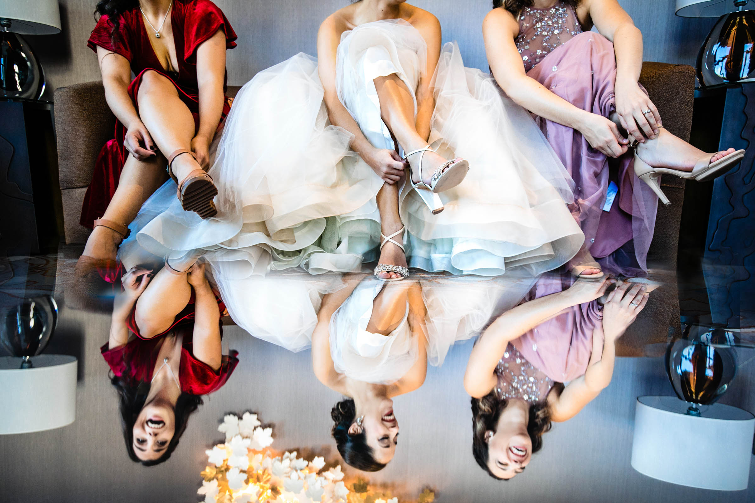 Reflection of bride and bridesmaids getting ready by Marissa Joy from Los Angeles