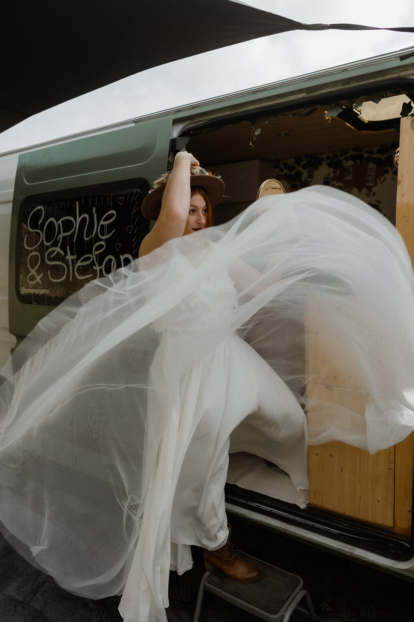 Creative portrait of bride with wedding veil swirling around her face for a dramatic fashion-inspired effect by Raini Rowell