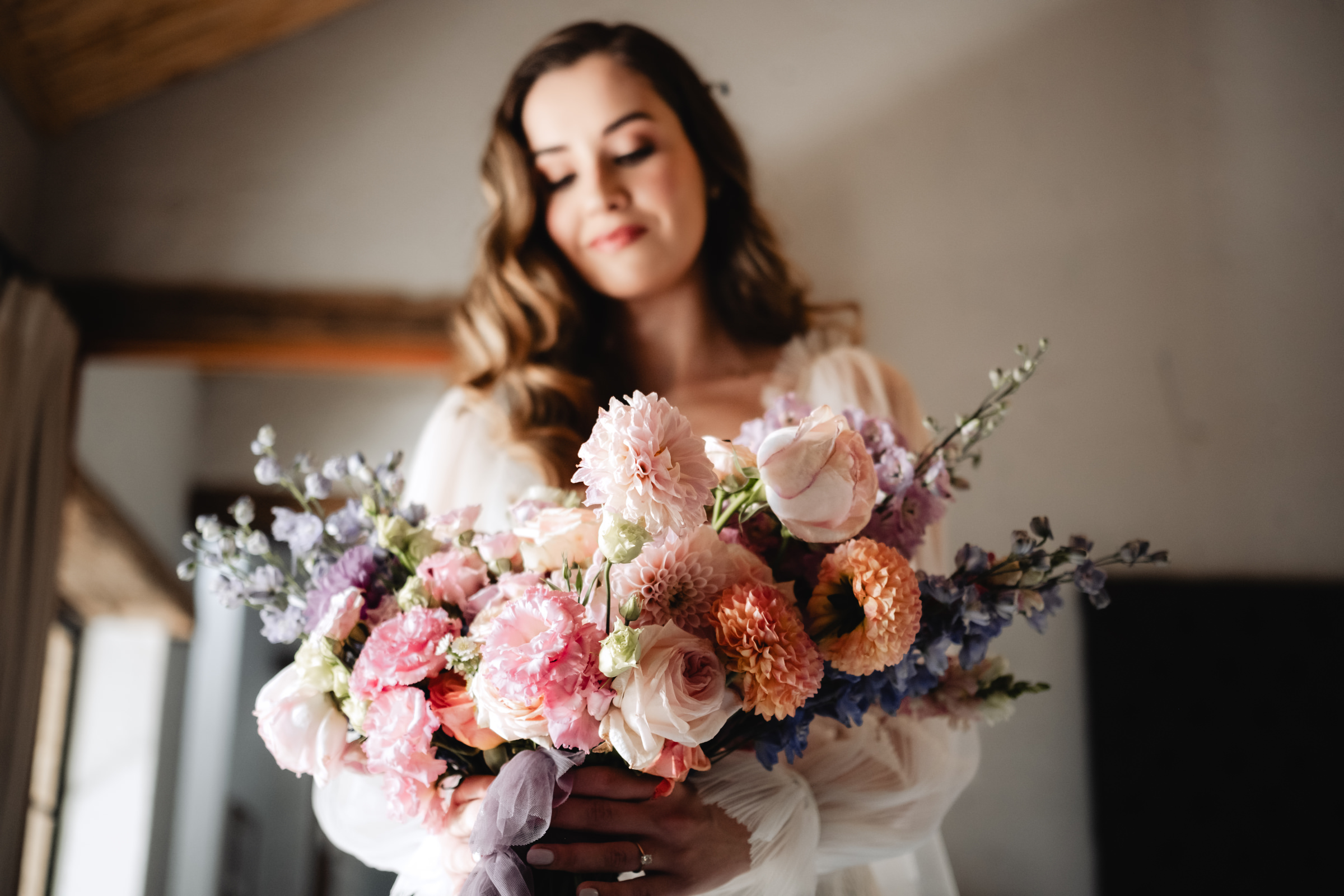 Bride holding giant dahlia bouquet