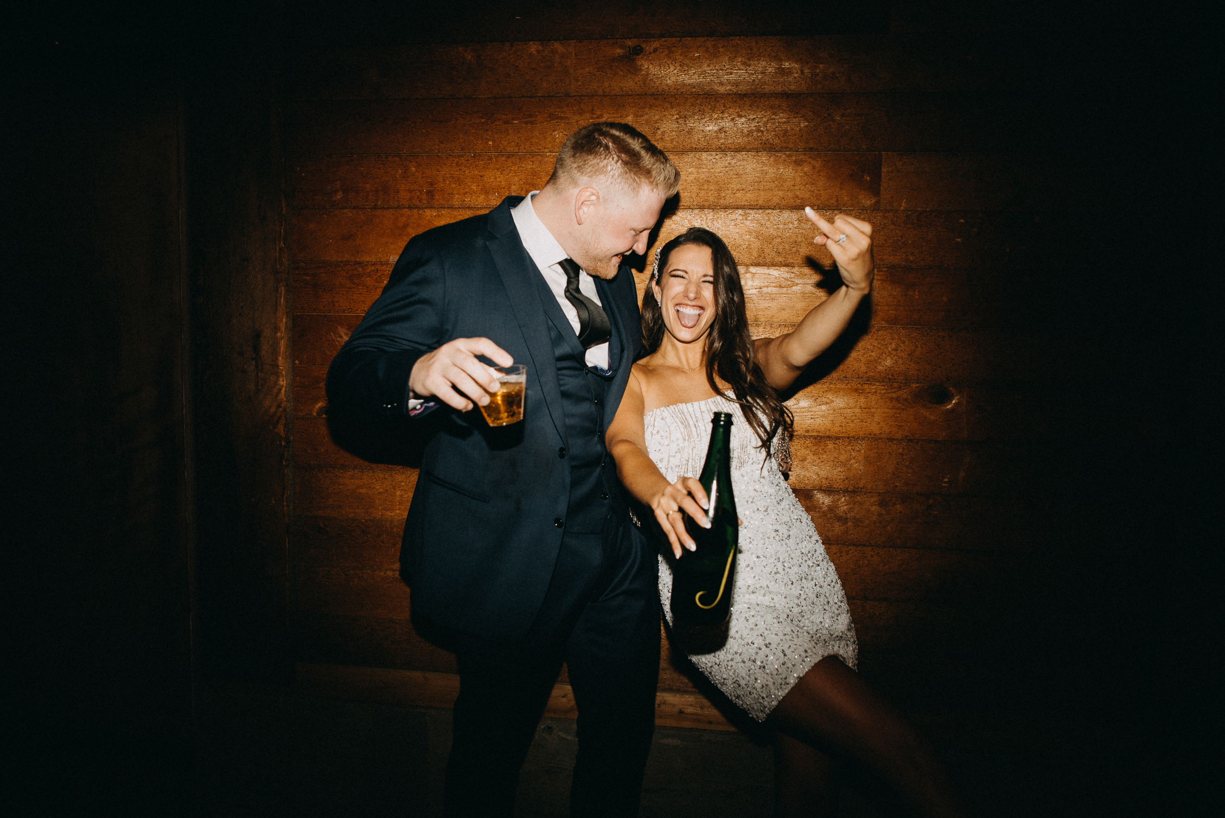 Couple happily popping the cork