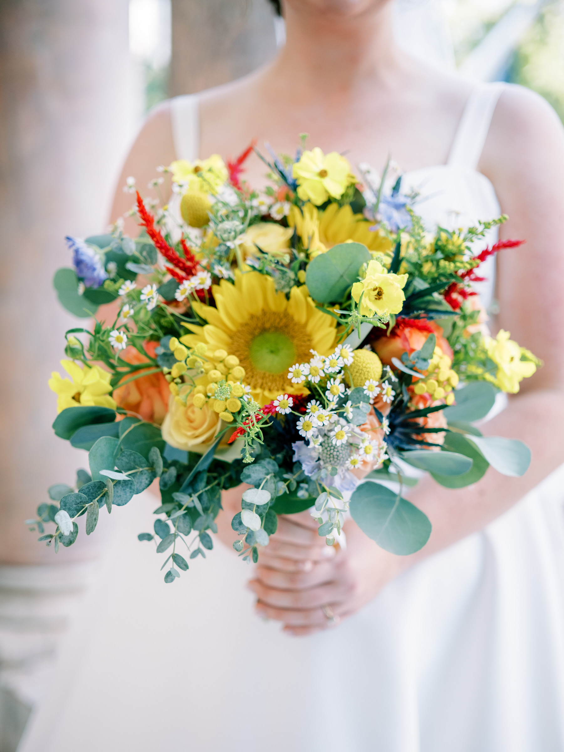 Cropped bride with bright summer bouquet