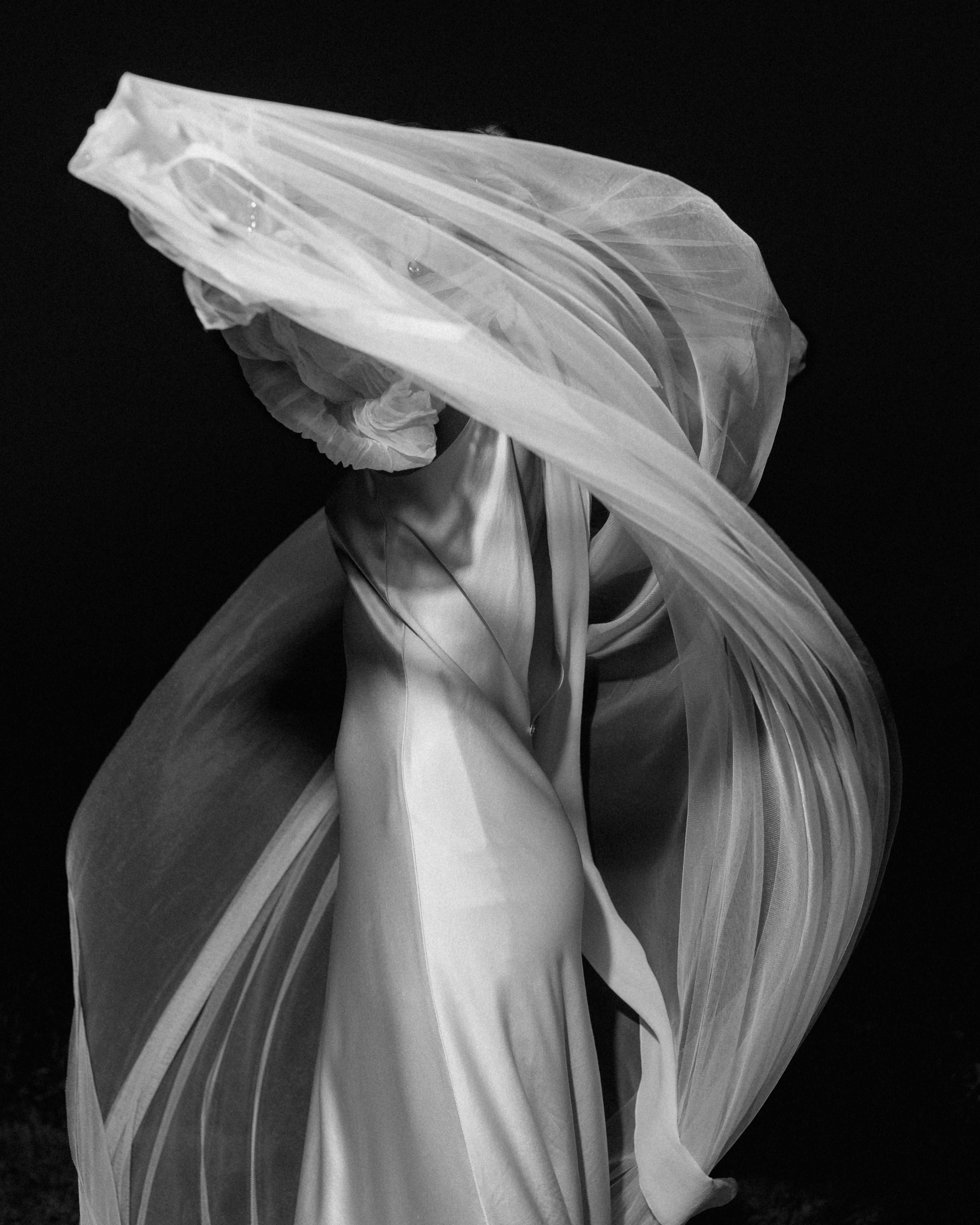Nighttime bridal portrait with ethereal wedding veil floating like mist captured by J. Olson Weddings