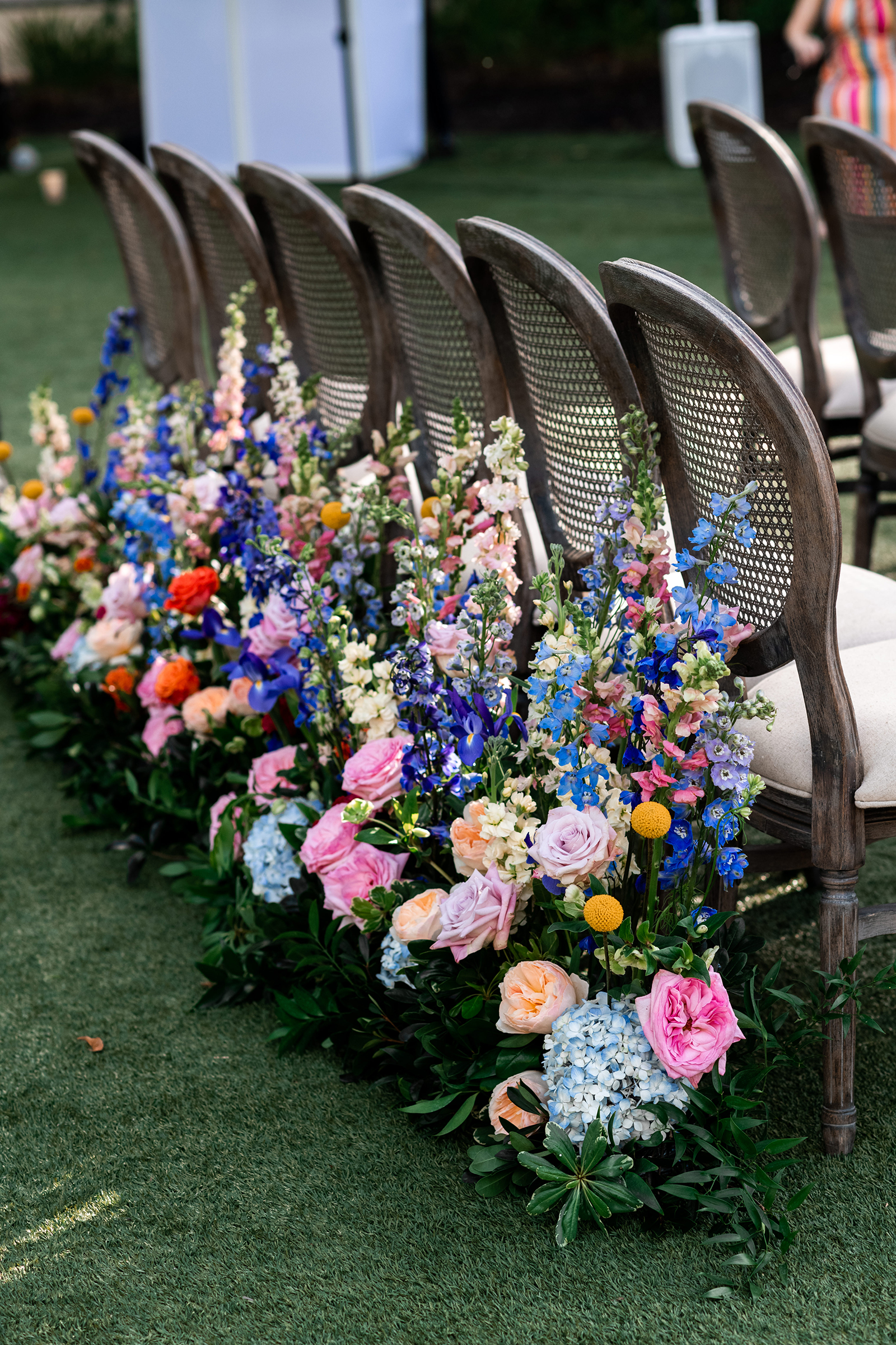 Bright bouquet adorning ceremony chairs