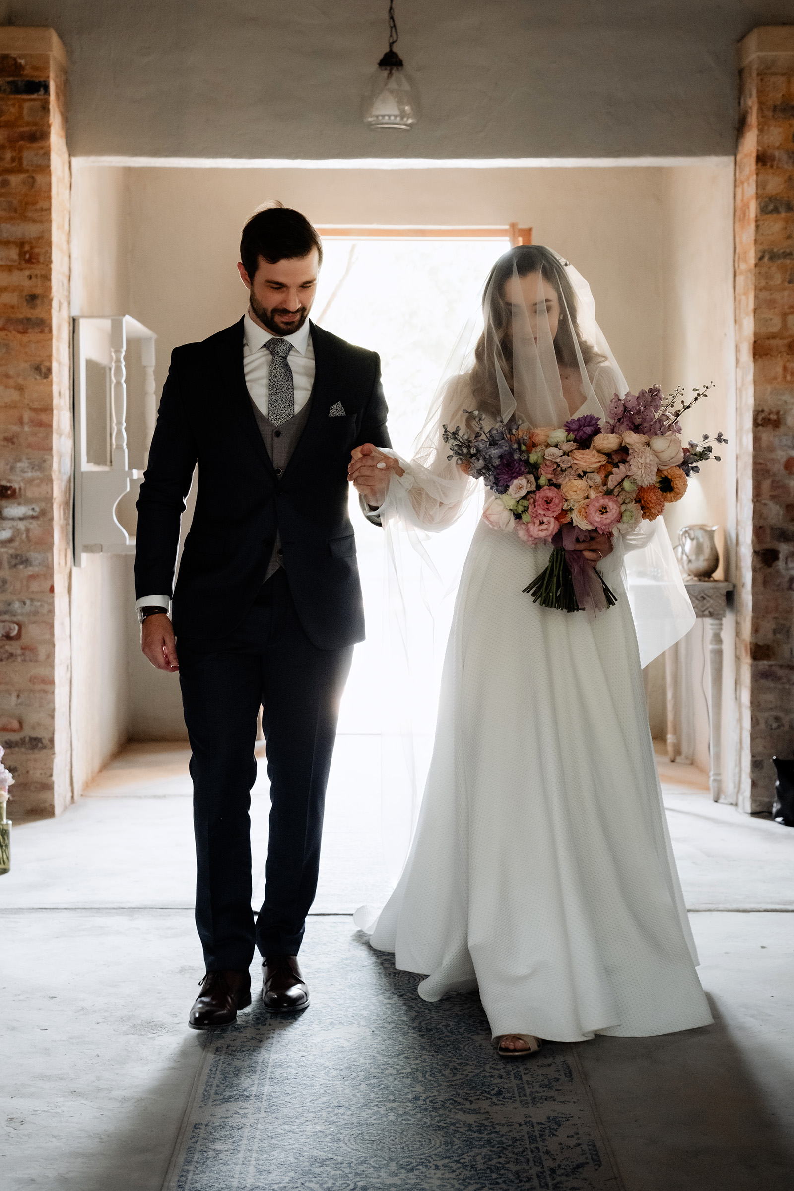 groom taking brides hand at Campagne Living - 