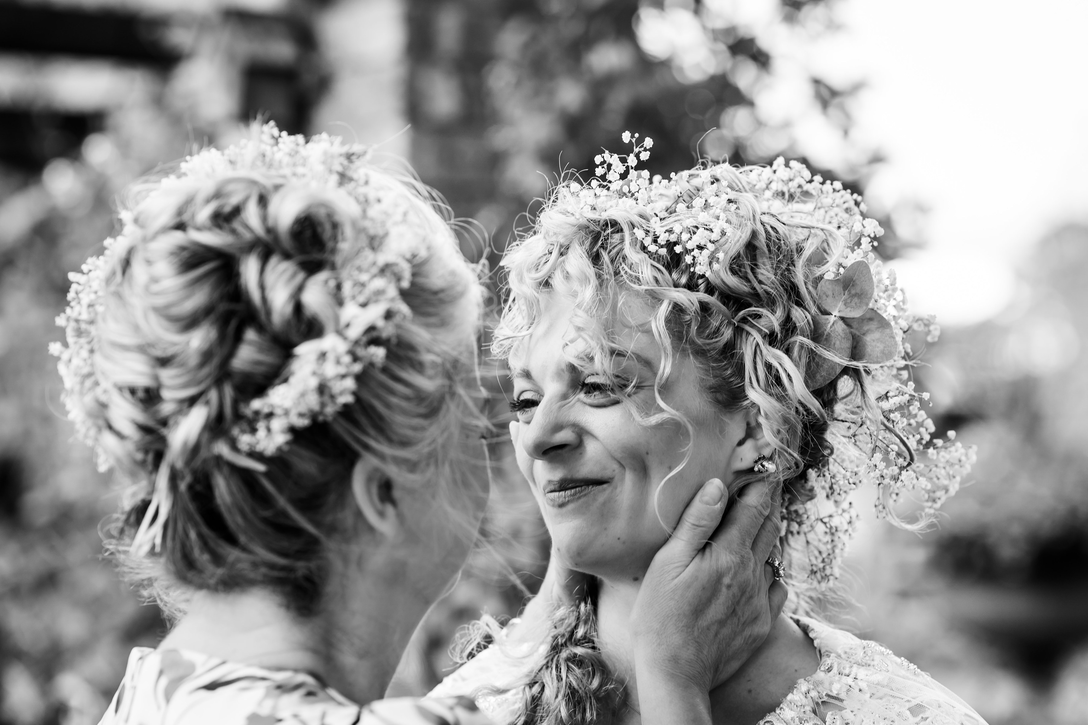Bride and mother having a tender moment after the ceremony