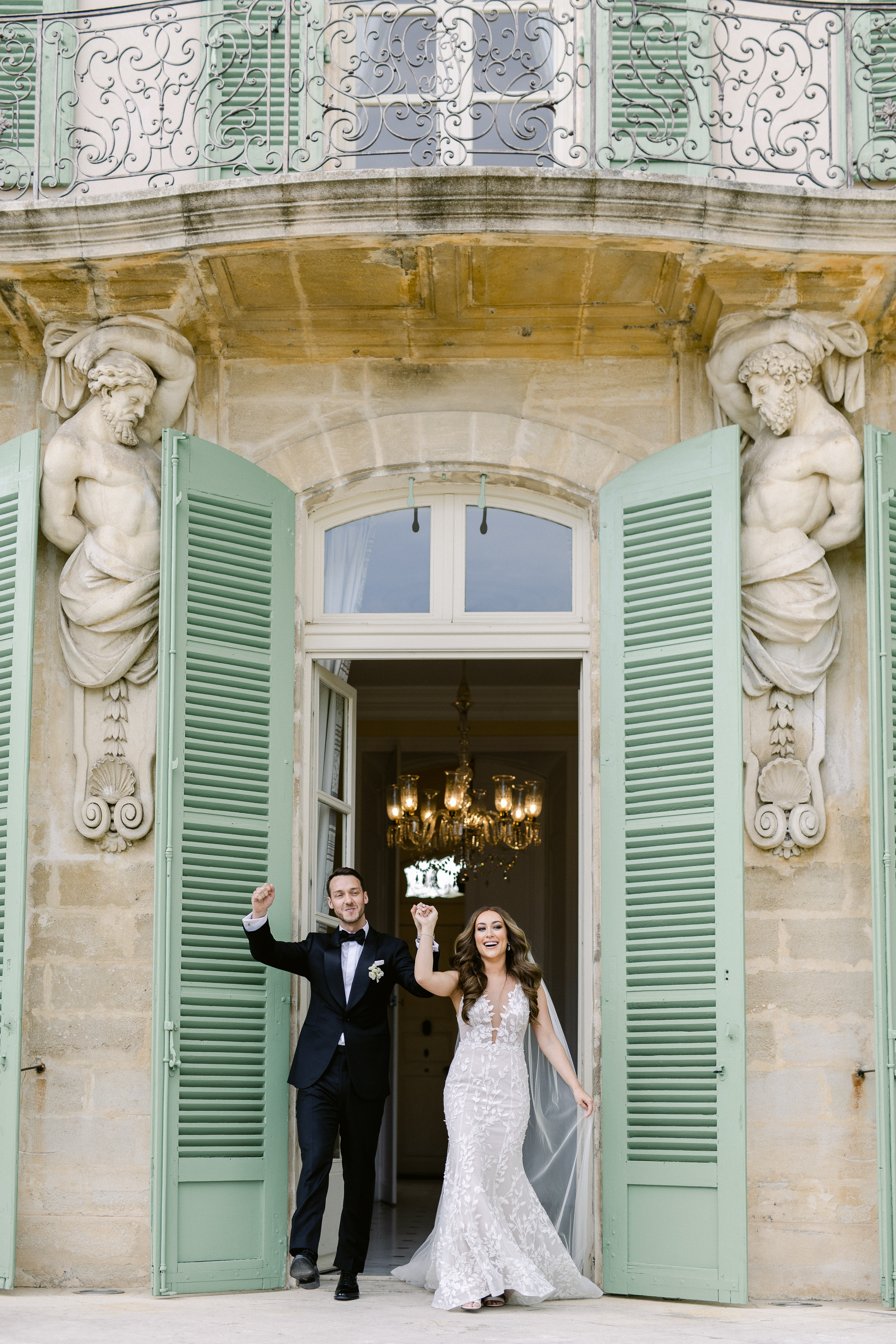 Couple  entering courtyard at Chateau de Torreau wedding, Provence