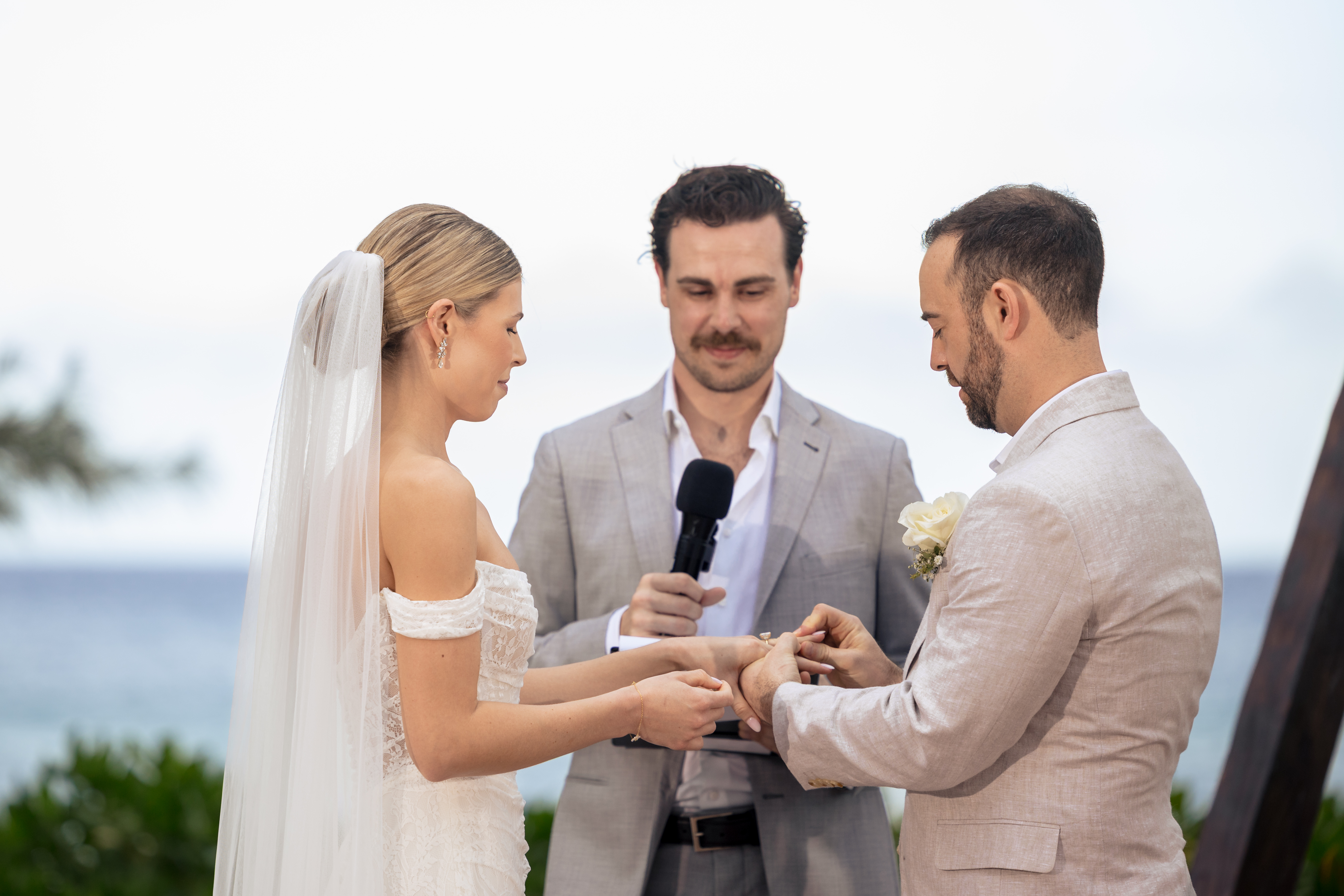 Couple exchanges rings-The Fives Beach Hotel Wedding by M.E.Photo & Films