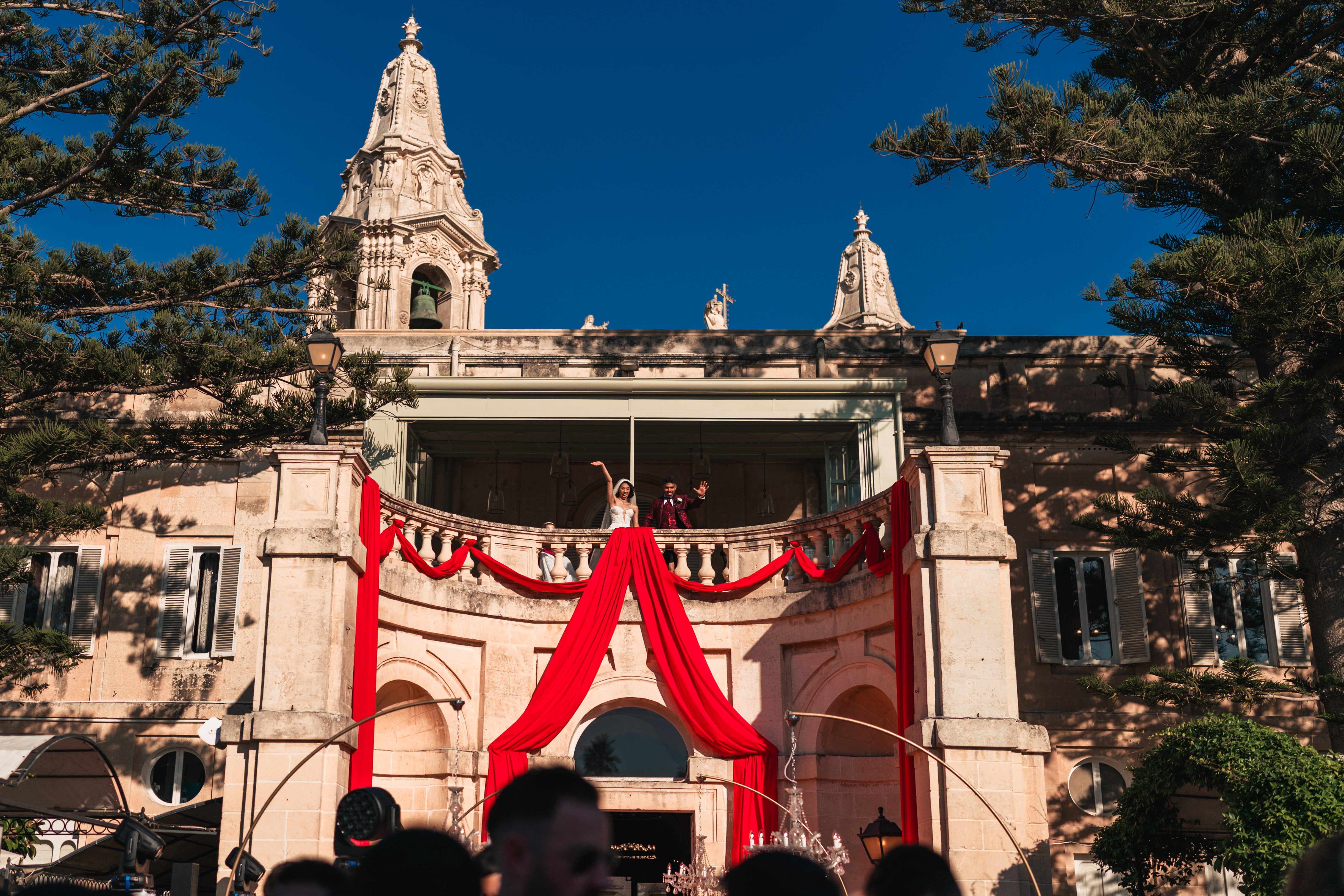 Palazzo Parisio wedding, couple waving from balcony, photographed by Franklin Balzan, Malta wedding photographer