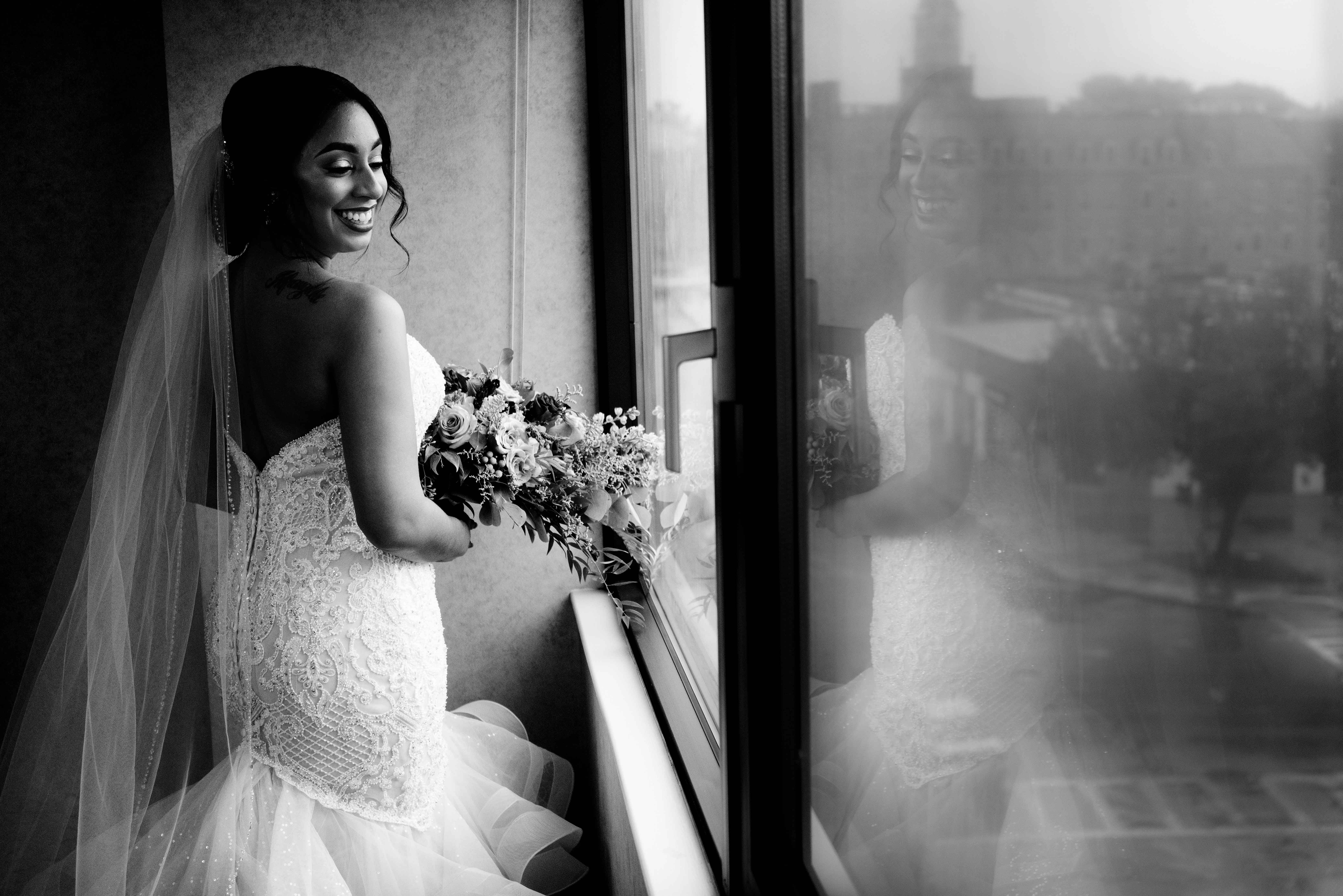back-view-of-smiling-bride-reflected-in-window-md-photo-films