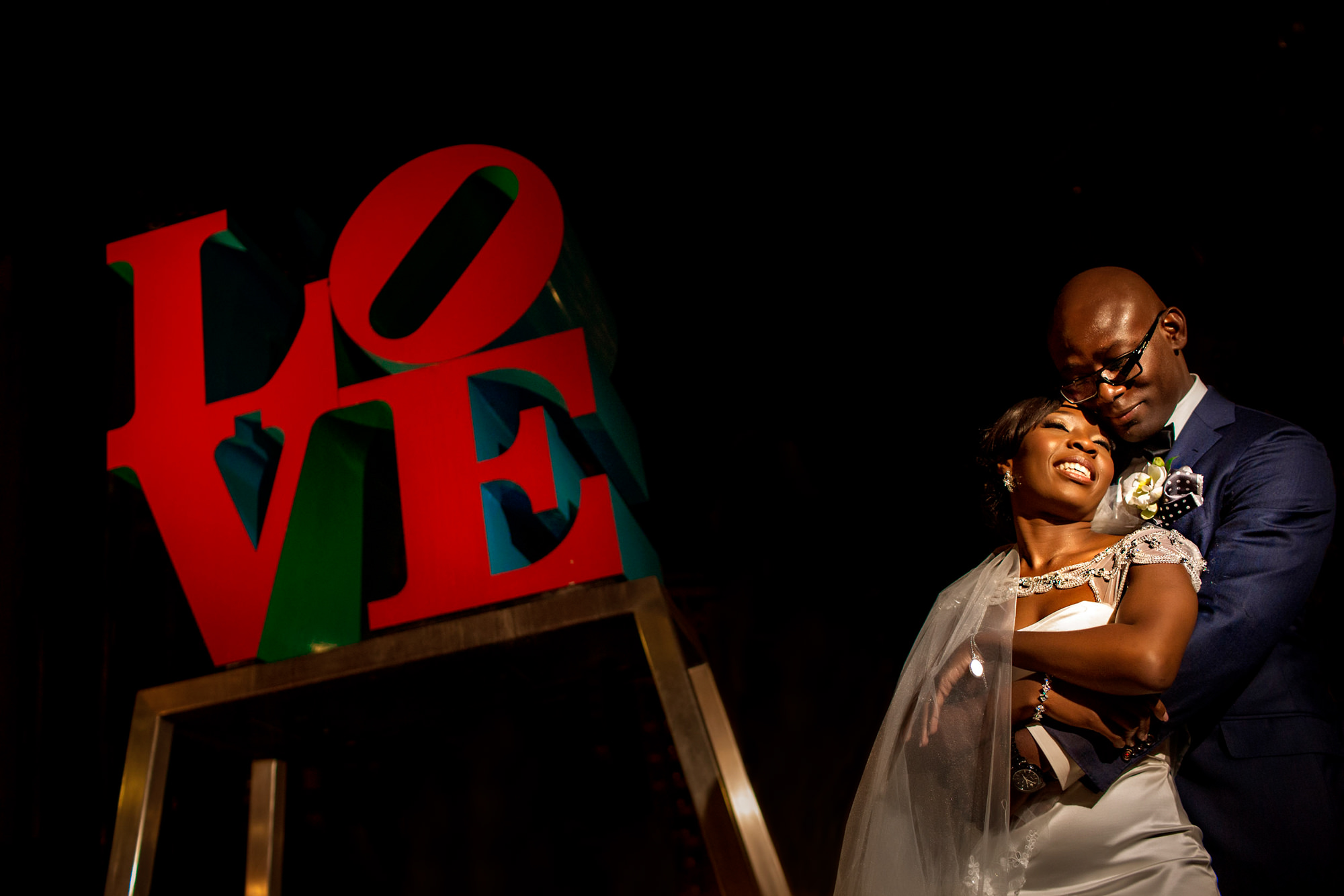black-bride-groom-in-front-of-iconic-love-sign-worlds-best-wedding-photos-jide-alakija-new-york-wedding-photographers