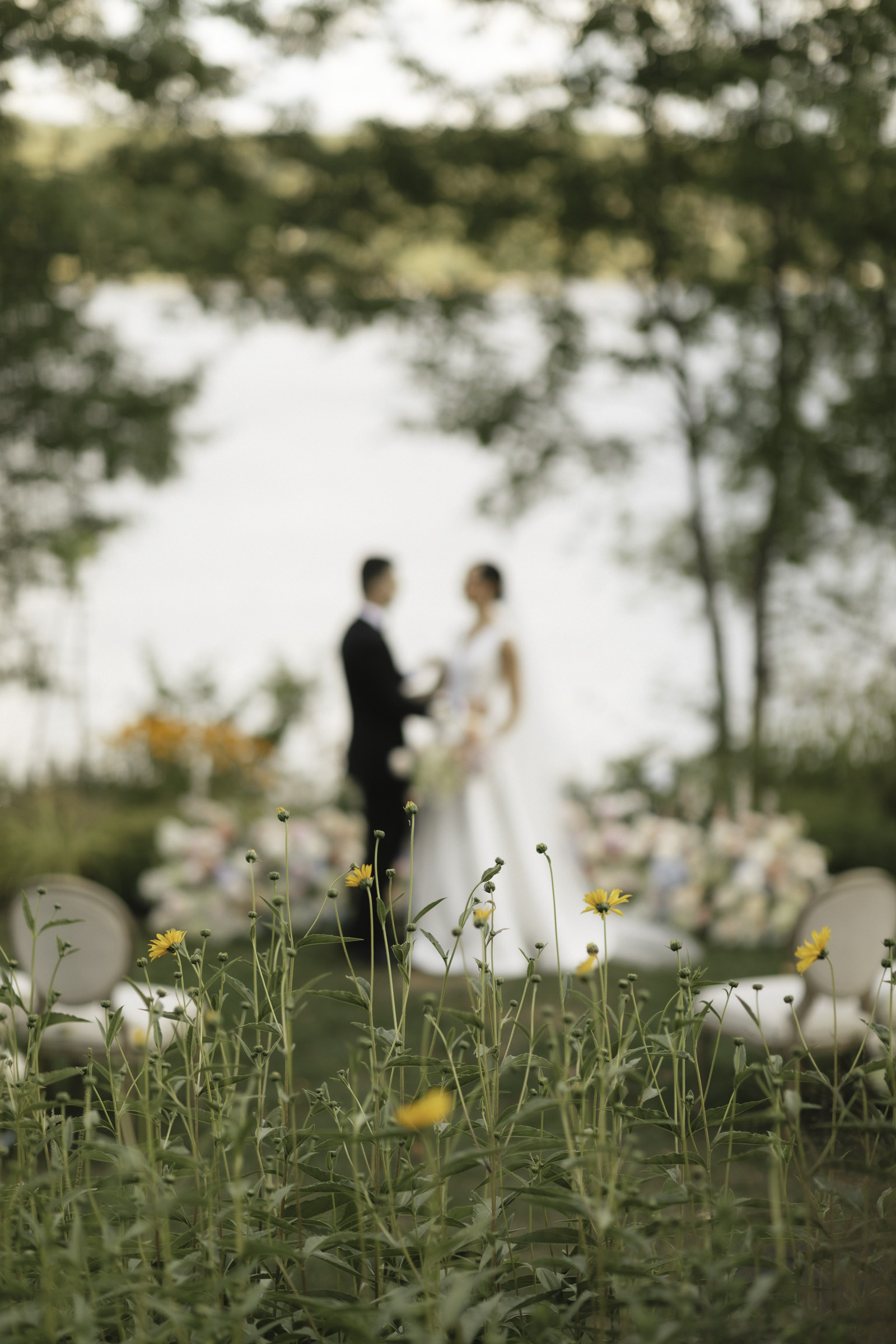 flowers with bride and groom in distance-Kerstin Hahn Photography