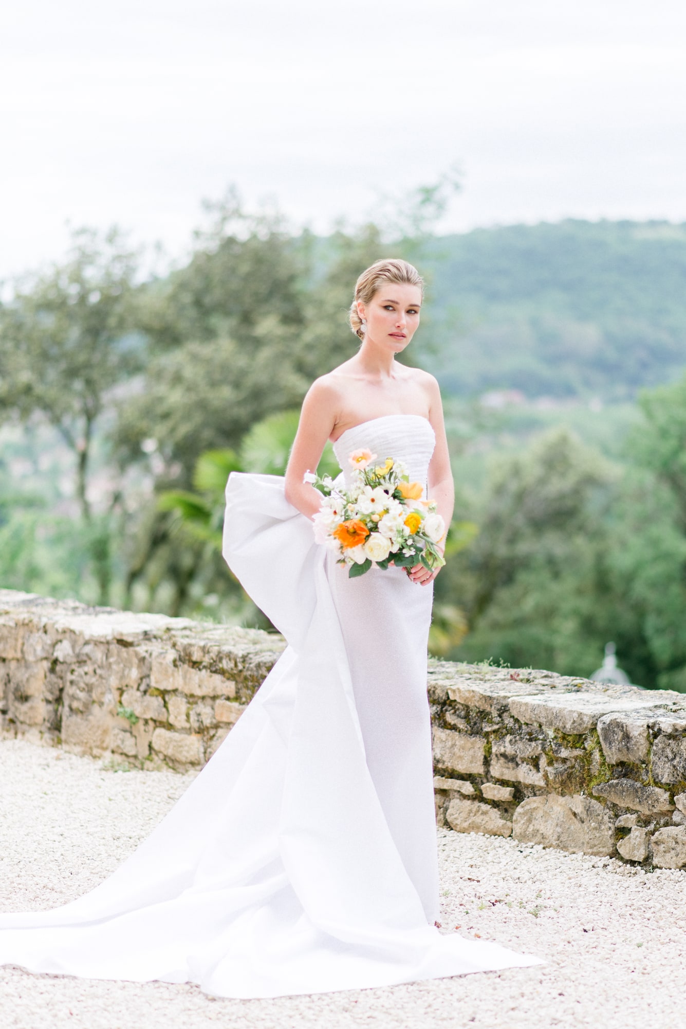 Elegant strapless wedding dress with soft ruching, photographed by Clemence Aresu, Paris wedding photographers