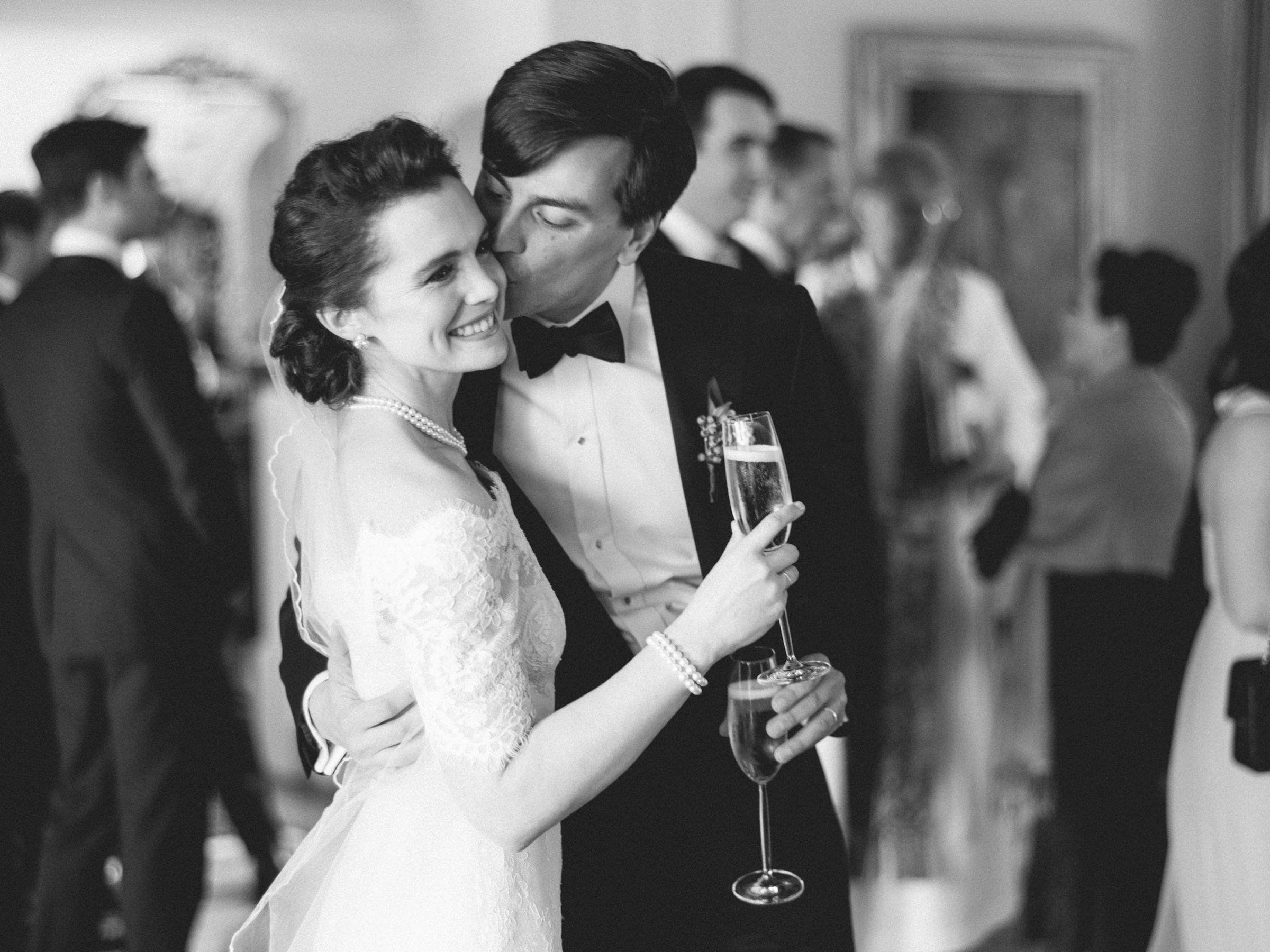 Black and white photo of groom kissing bride by Amy and Stuart from Los Angeles