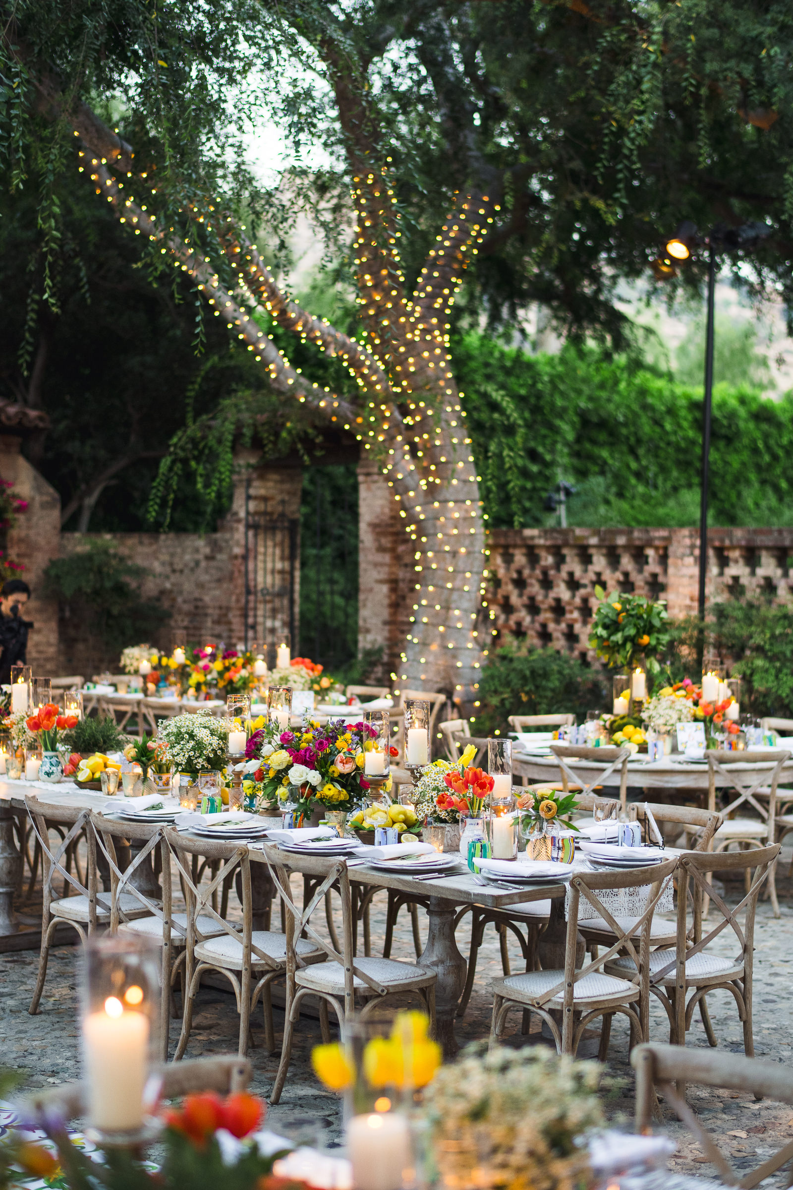 Colorful outdoor tables with candlelight, photographed by Callaway Gable Photography, Los Angeles celebrity wedding photographers