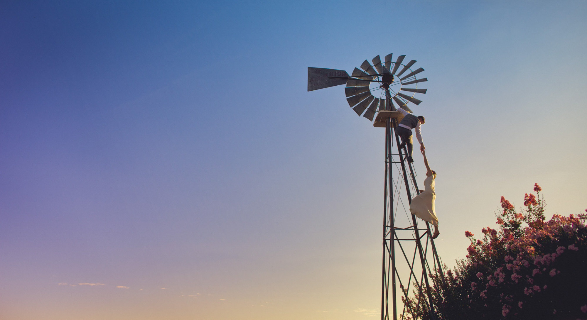 Couple climbing wind tower by Jeff Newsom from San Luis Obispo