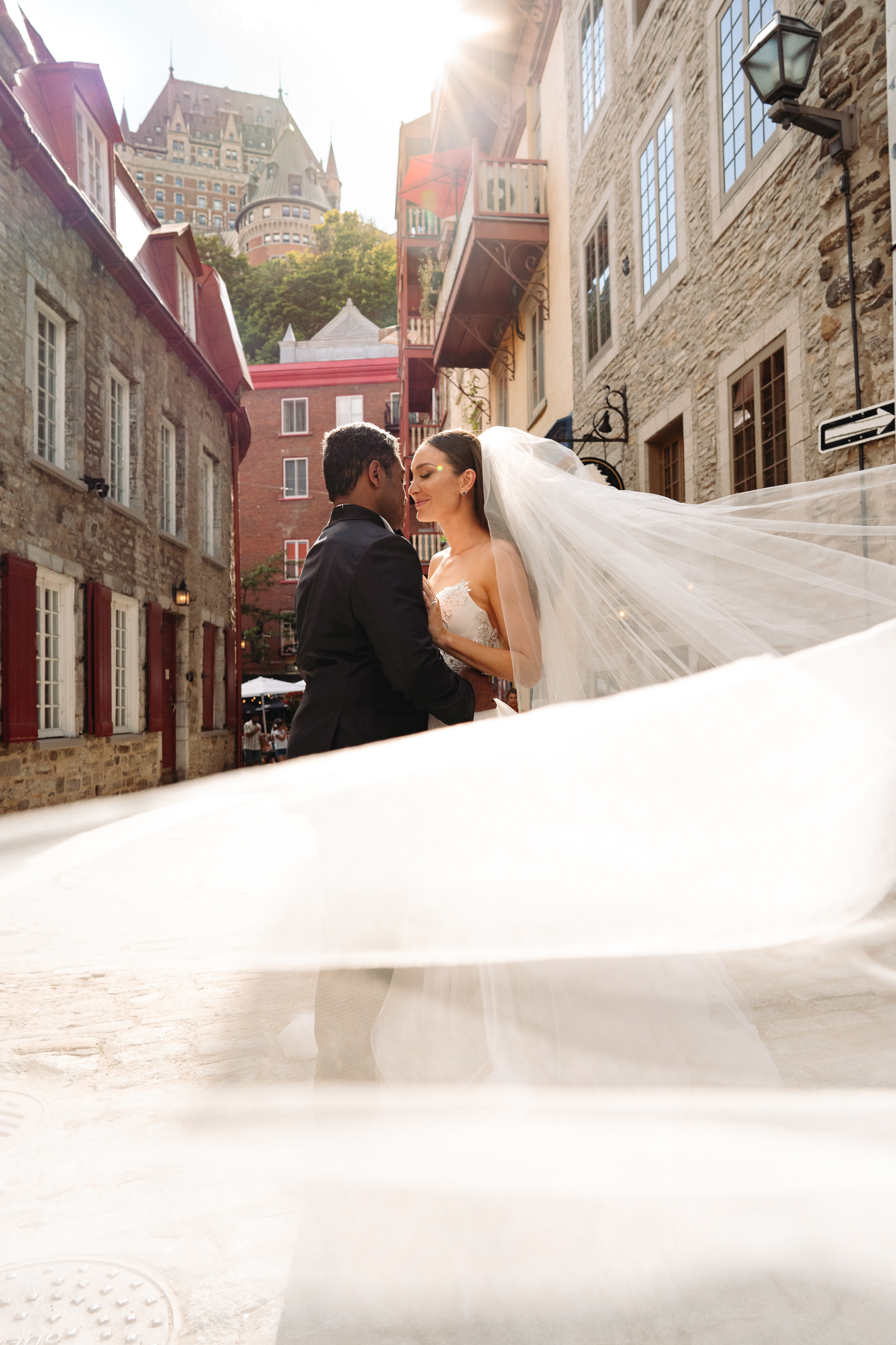 Couple portrait with veil blowing-Annie Simard Photography