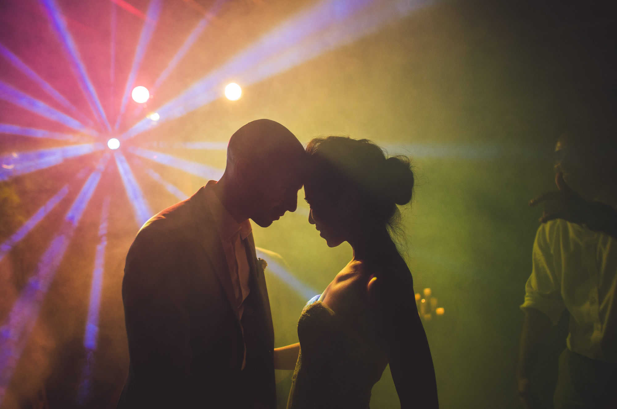 Couple in colorful dance floor light show during reception by Jeff Newsom, San Luis Obispo