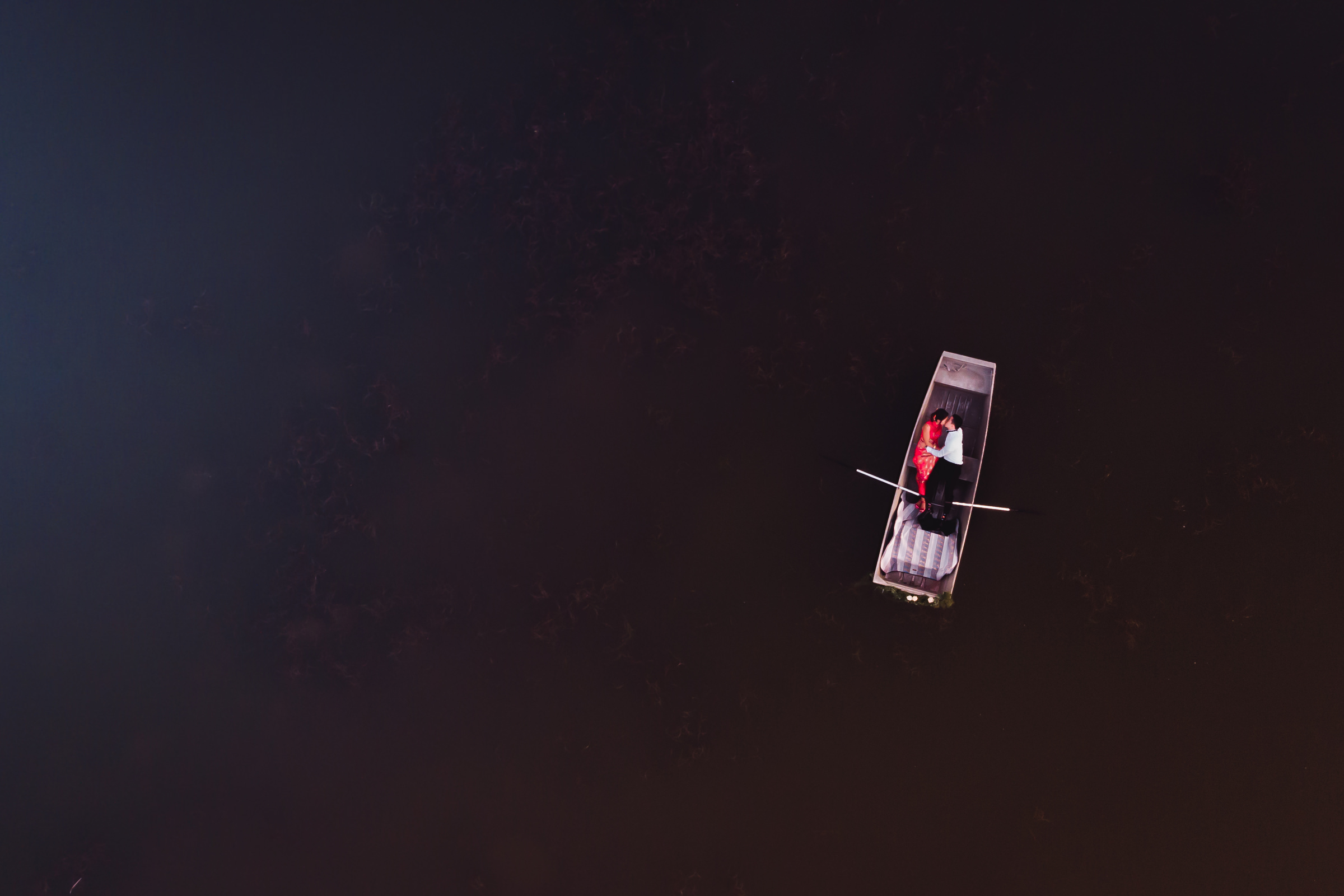 drone-view-of-couple-reclining-in-rowboat-ein-photography-and-design