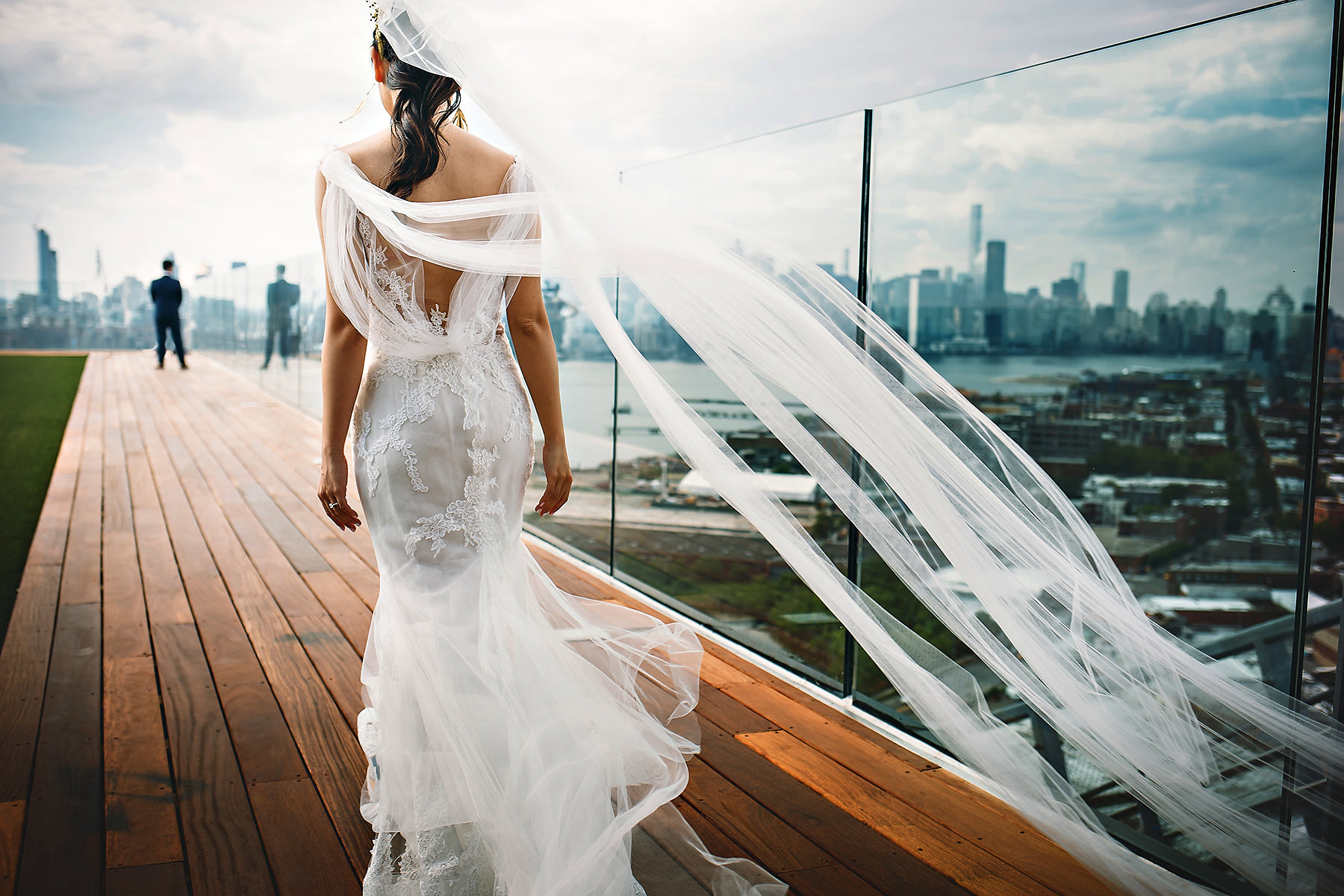 Bride approaching groom on rooftop deck - best New York wedding photographers