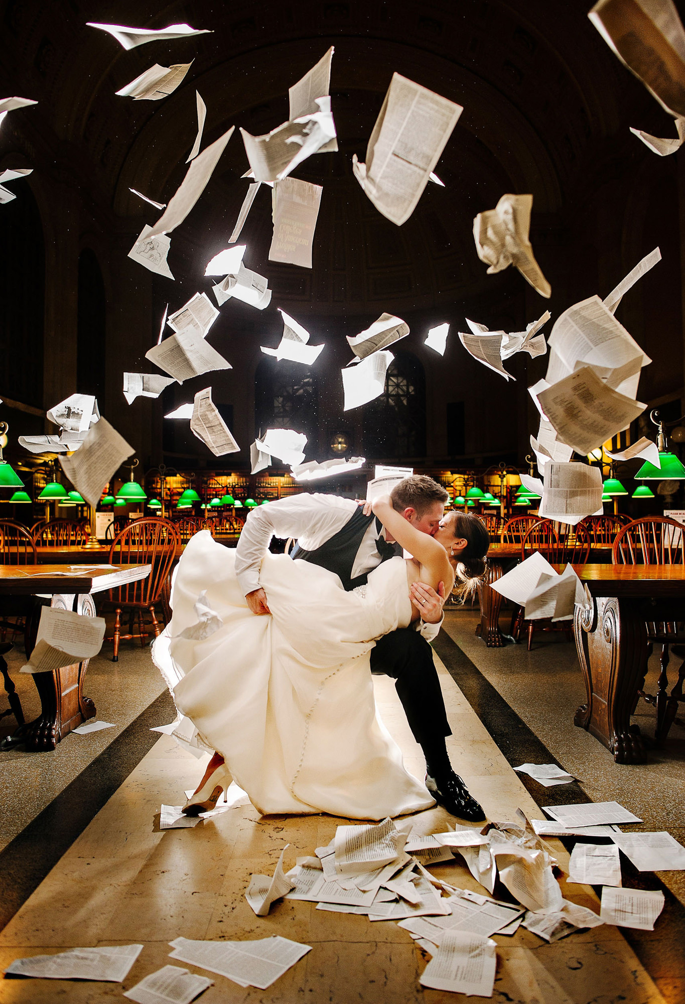 epic-bride-and-groom-kissing-portrait-in-library-with-flying-papers-worlds-best-wedding-photos-the-brenizers-new-york-wedding-photographers