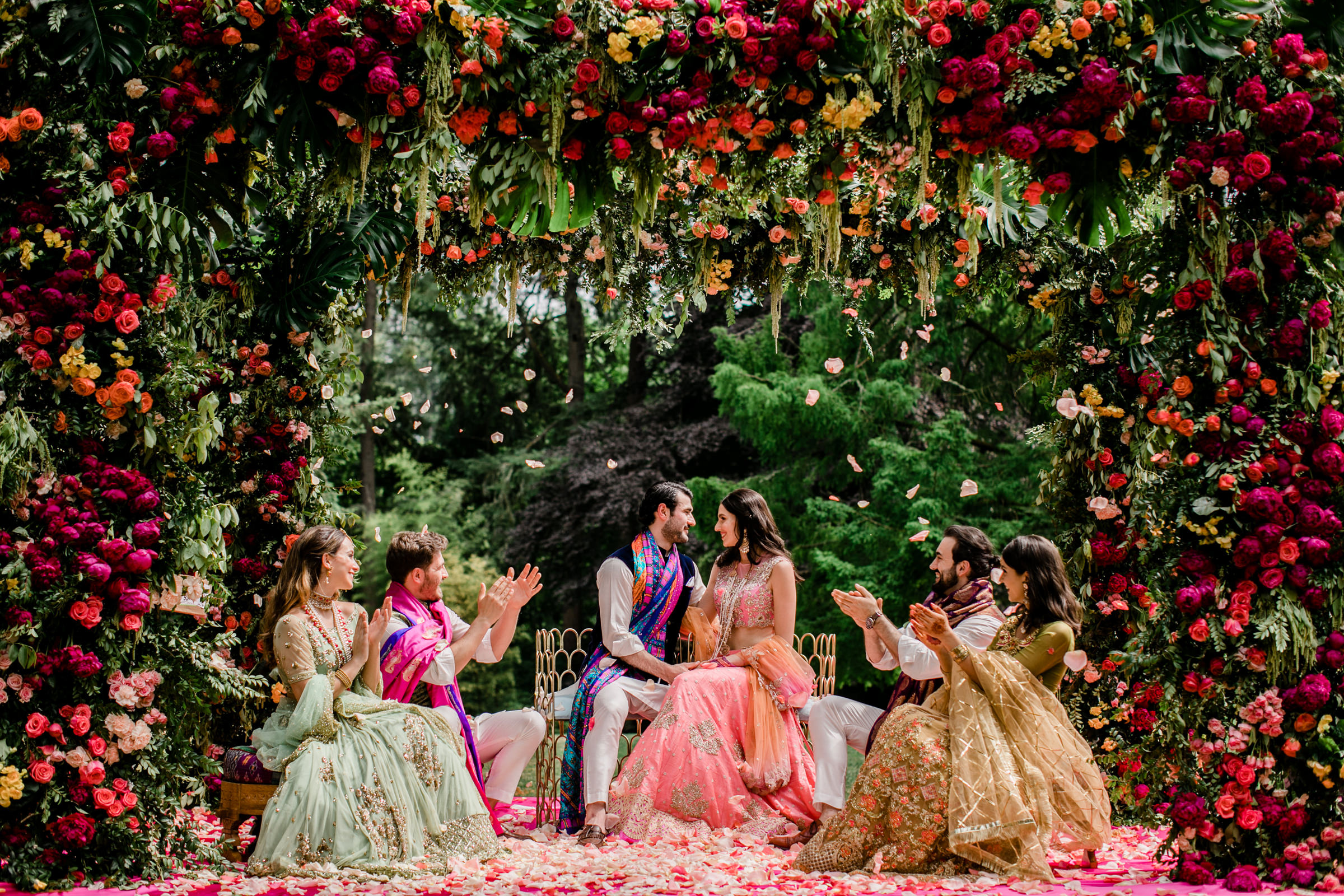 Elaborate floral arbor with red, purple, and pink roses photographed by Into Dust Photography - Seattle