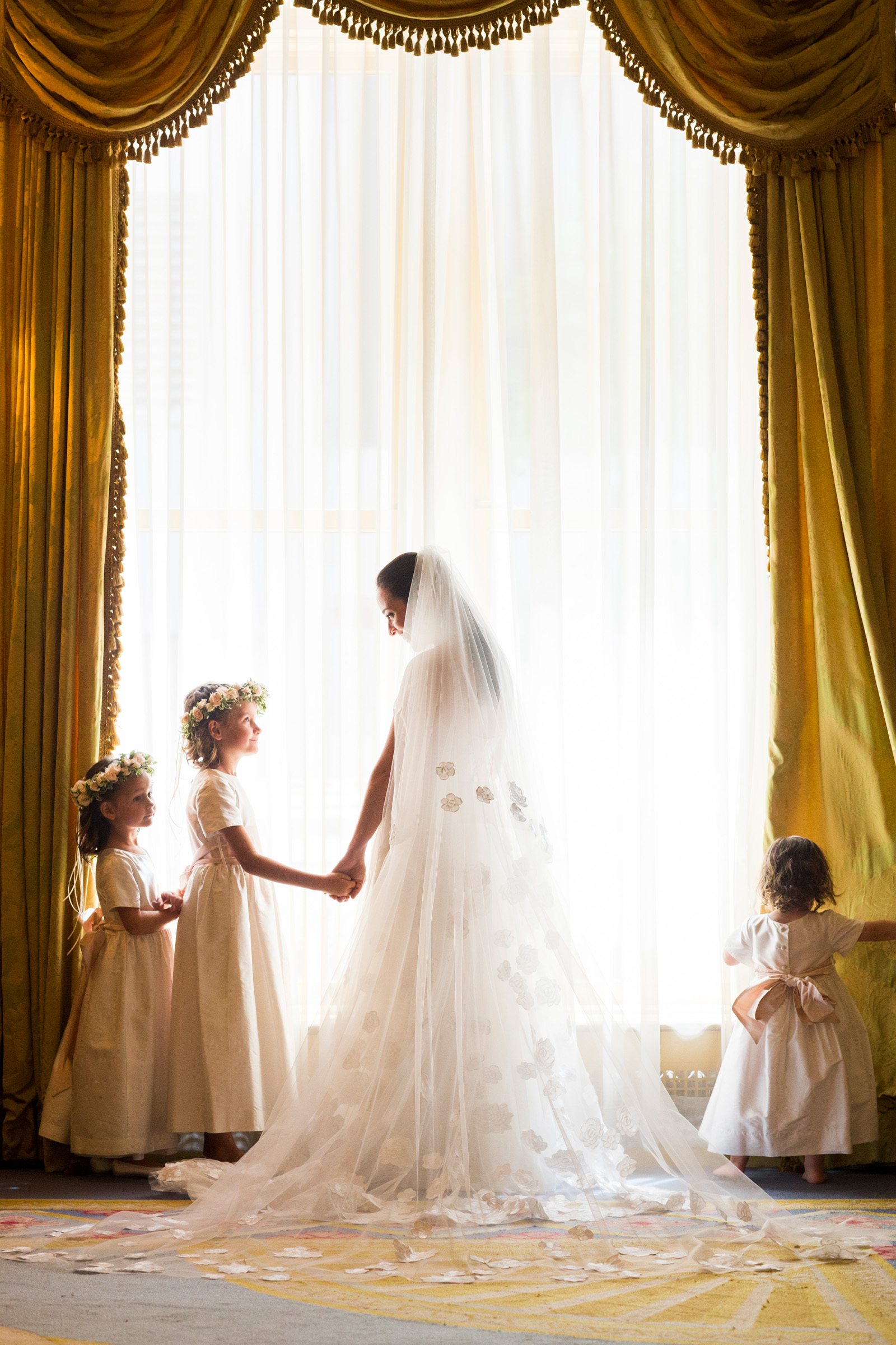 flower-girls-with-bride-at-curtained-and-draperied-window-berit-bizjak-photography