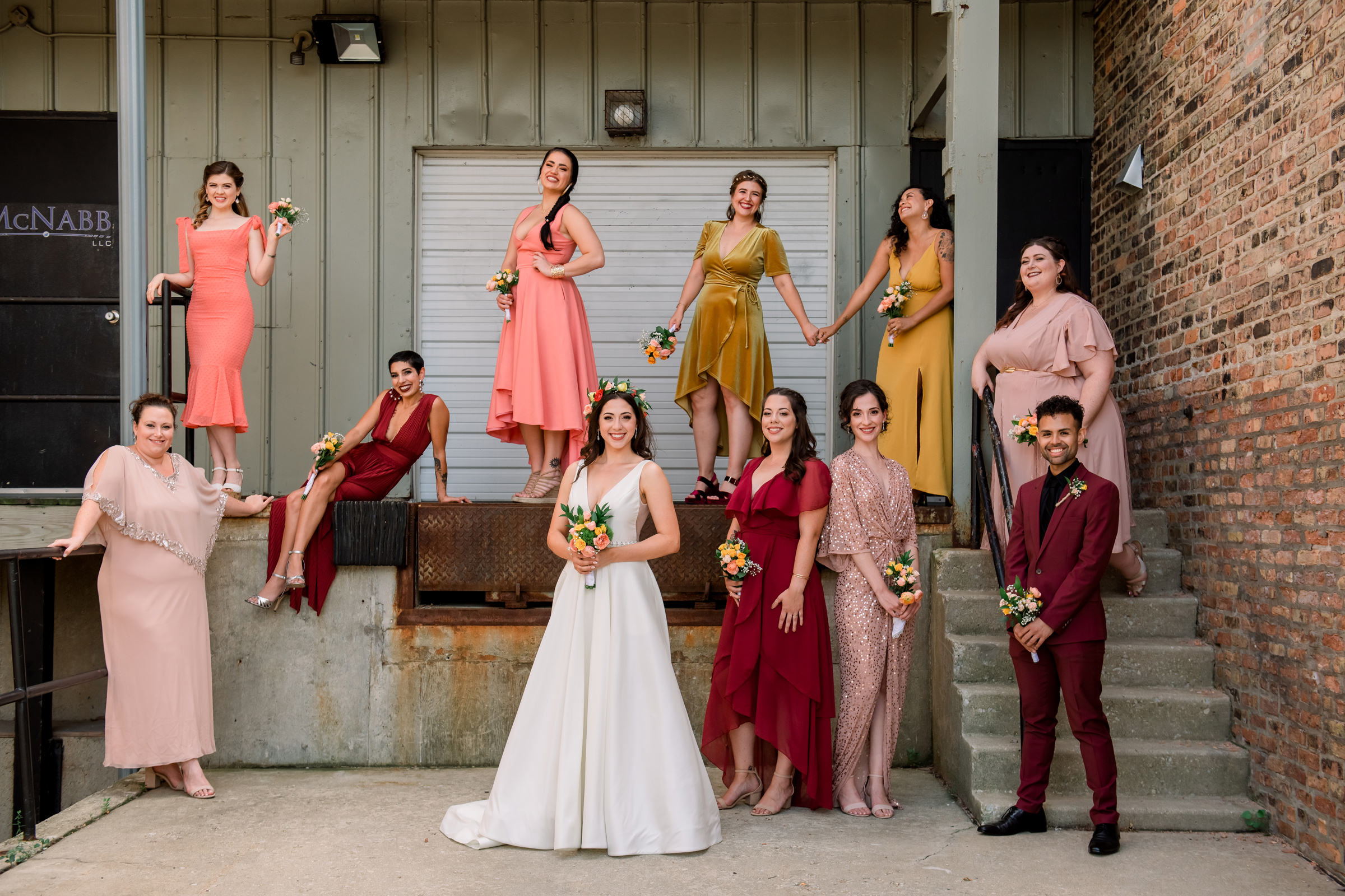 Group shot of bridal party in red, coral, photographed by Mike Zawadzki - New Jersey