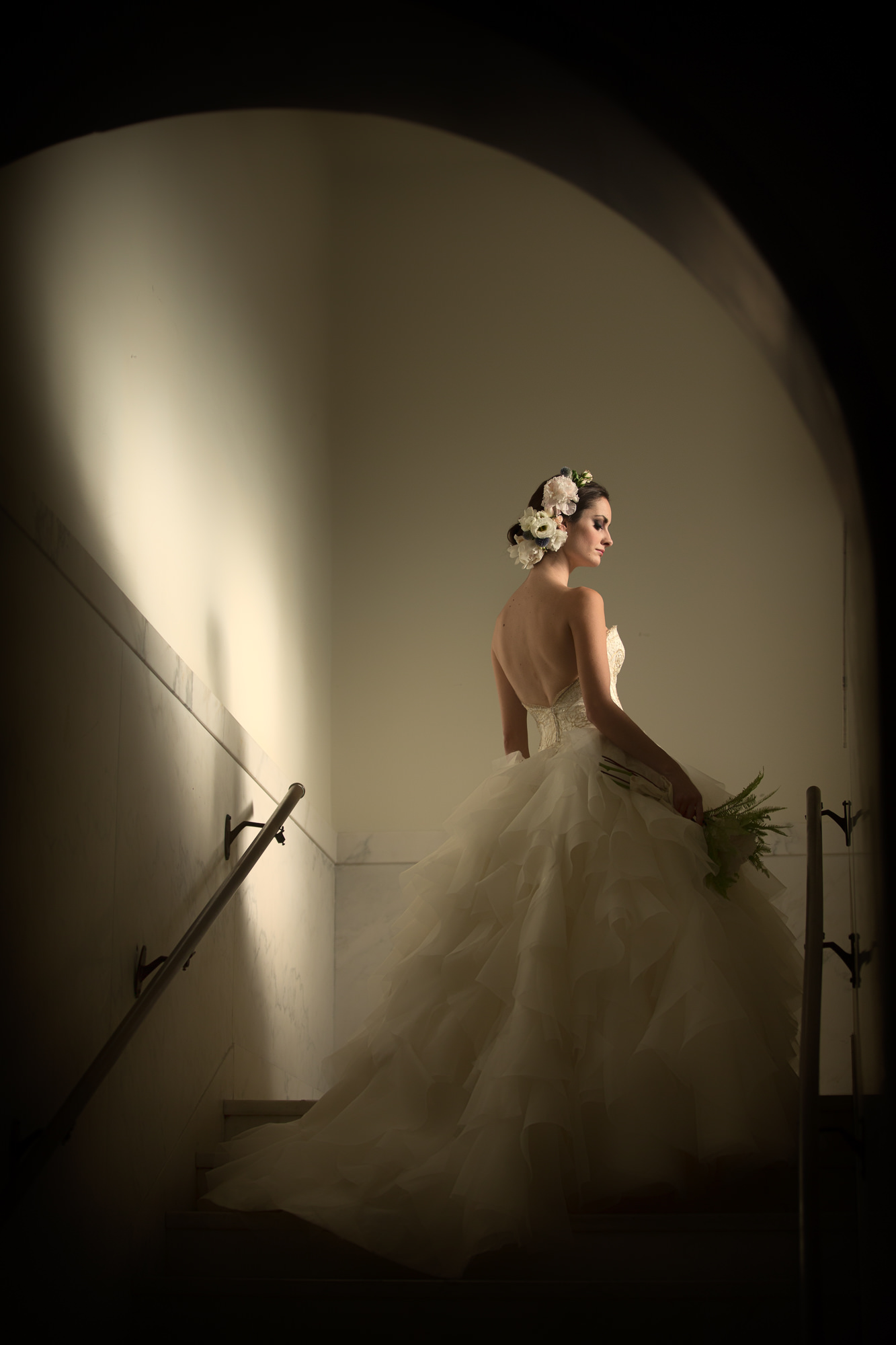 Bride in Monique Lhuillier backless ruffled gown by Roberto Valenzuela, Los Angeles