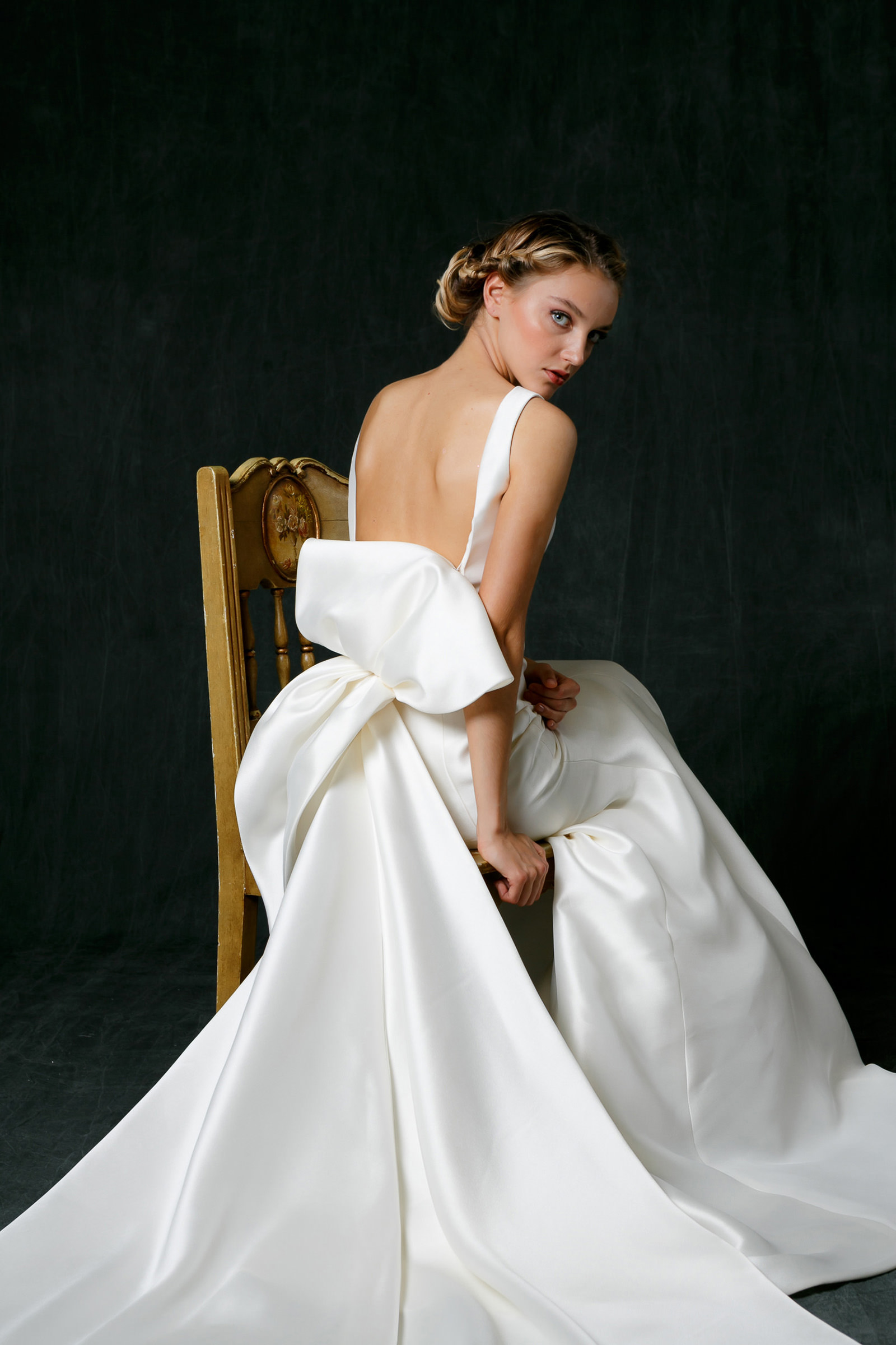 seated-bride-portrait-in-backless-satin-gown-with-large-bow-photo-by-syphotography
