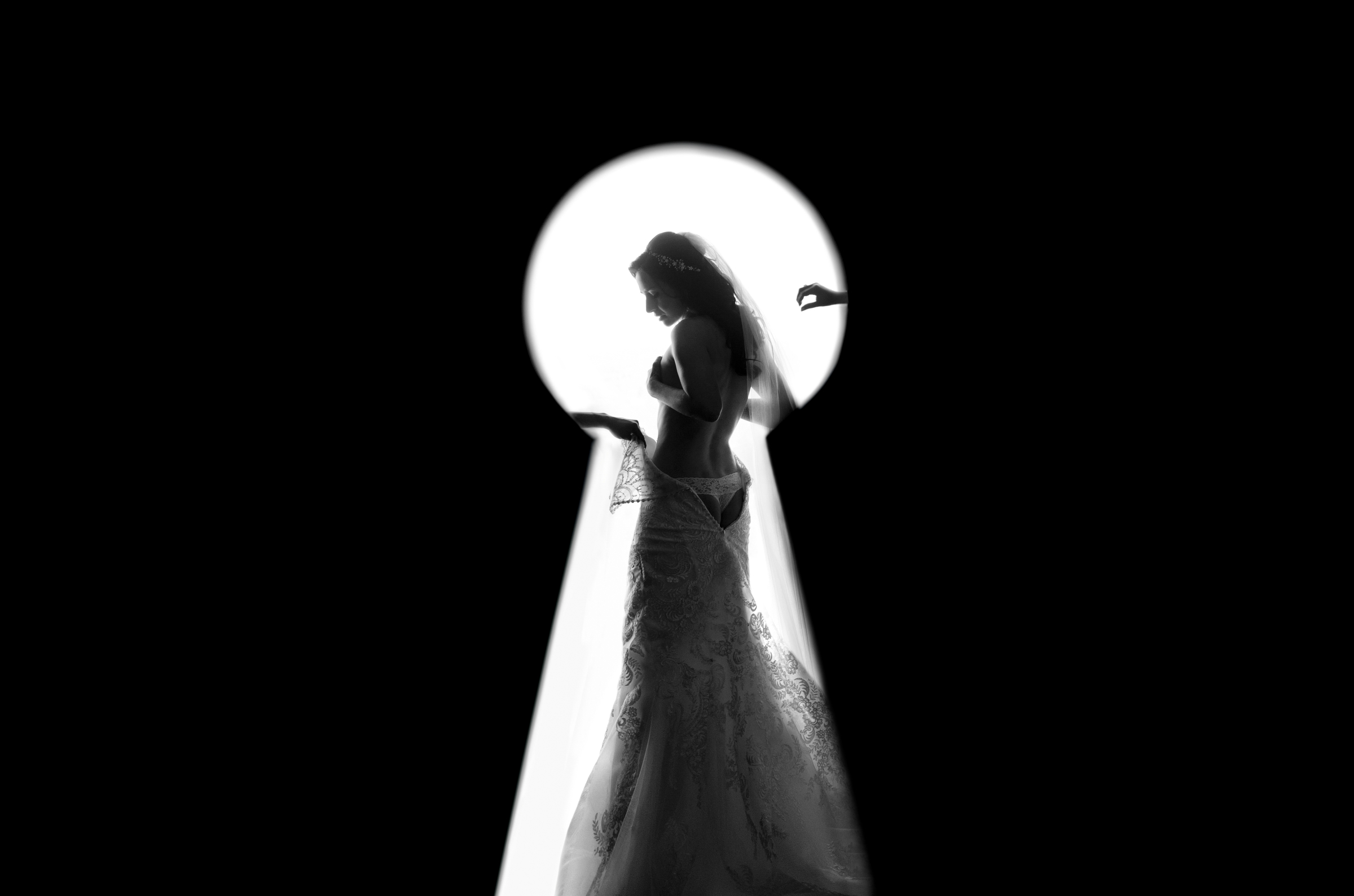 seen-through-keyhole-bride-getting-into-her-gown-matthew-sowa-photography