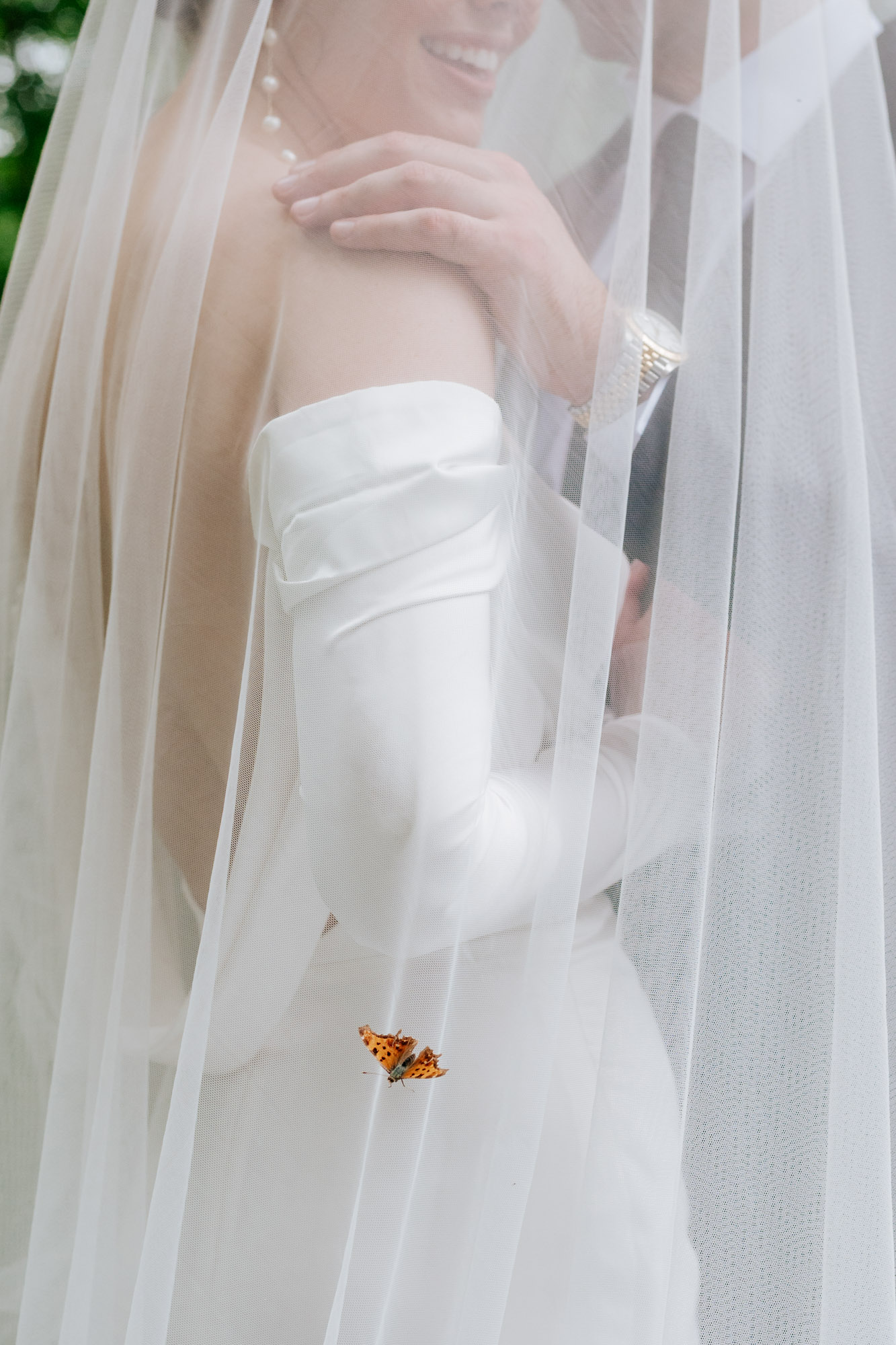 butterfly landing on brides dress-Mirona Photographe