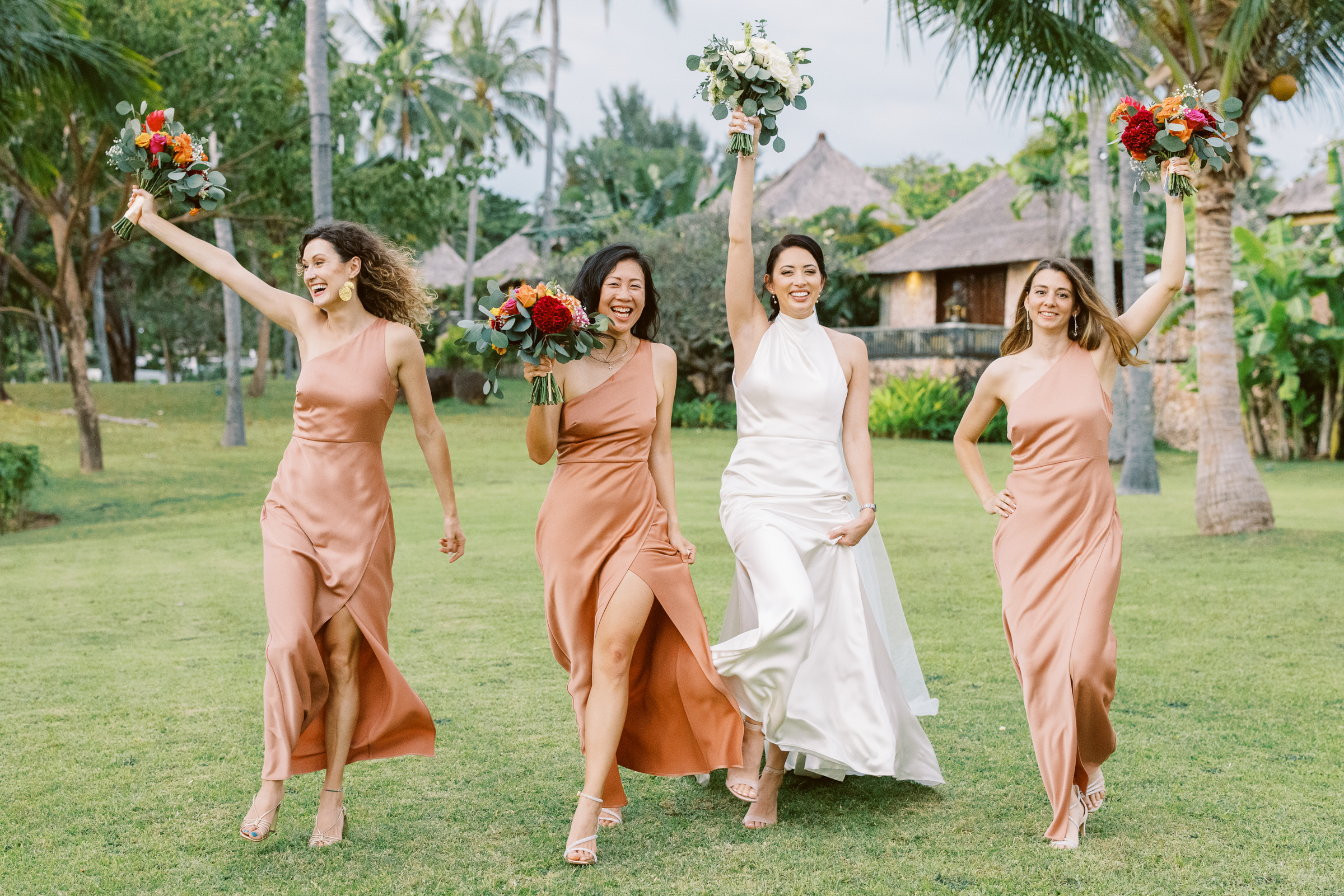 Bridesmaids running with bride at the Oberoi Resort Lombok, Sylvain Bouzat Photography