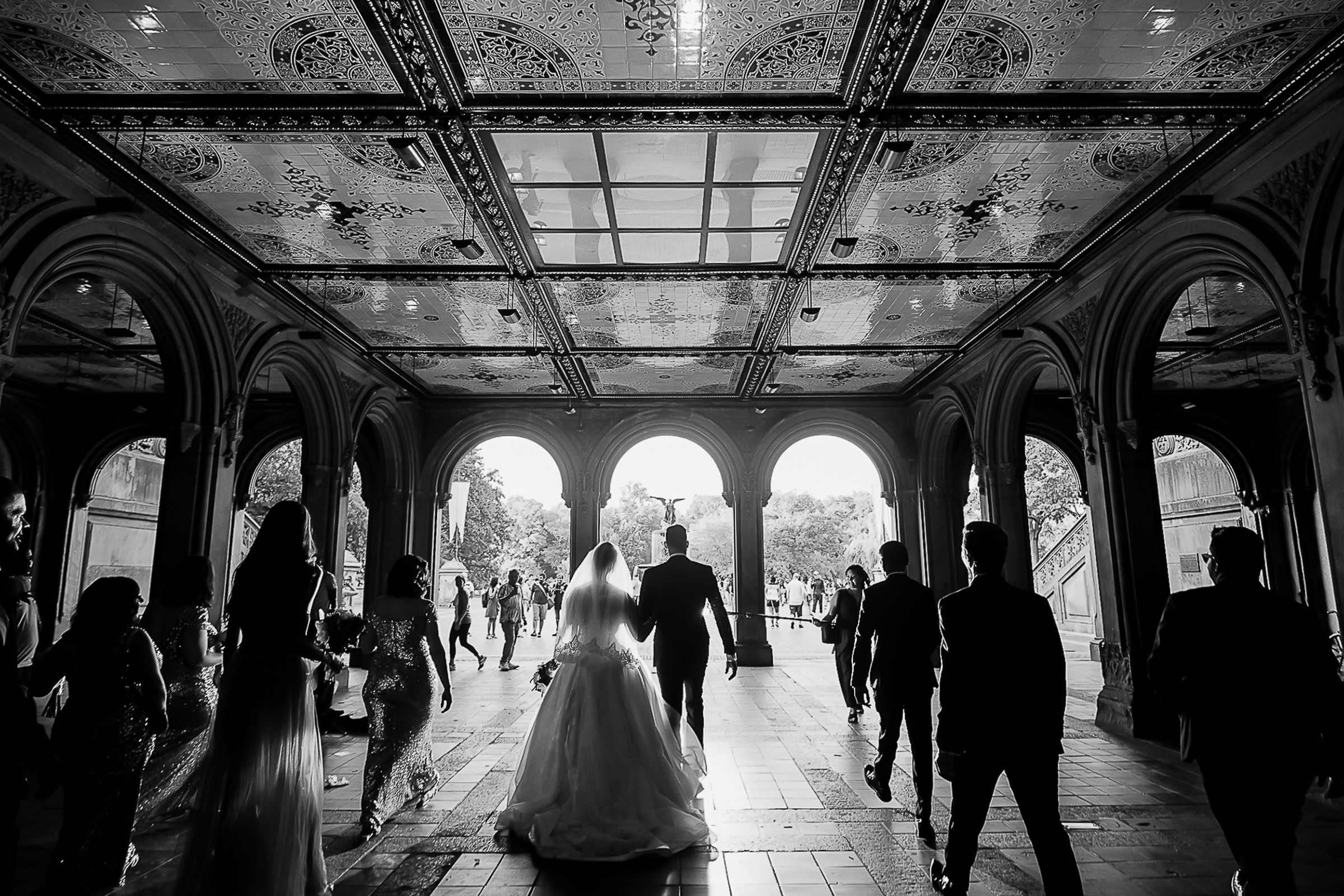 wedding-party-walking-toward-arches-photo-by-kesha-lambert-photography