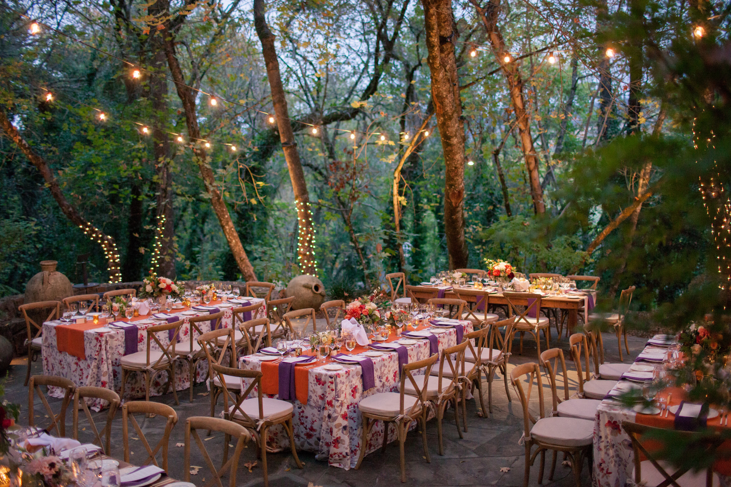 Woodland lighted reception with floral tablecloths photographed by Modernmade Weddings - Florida