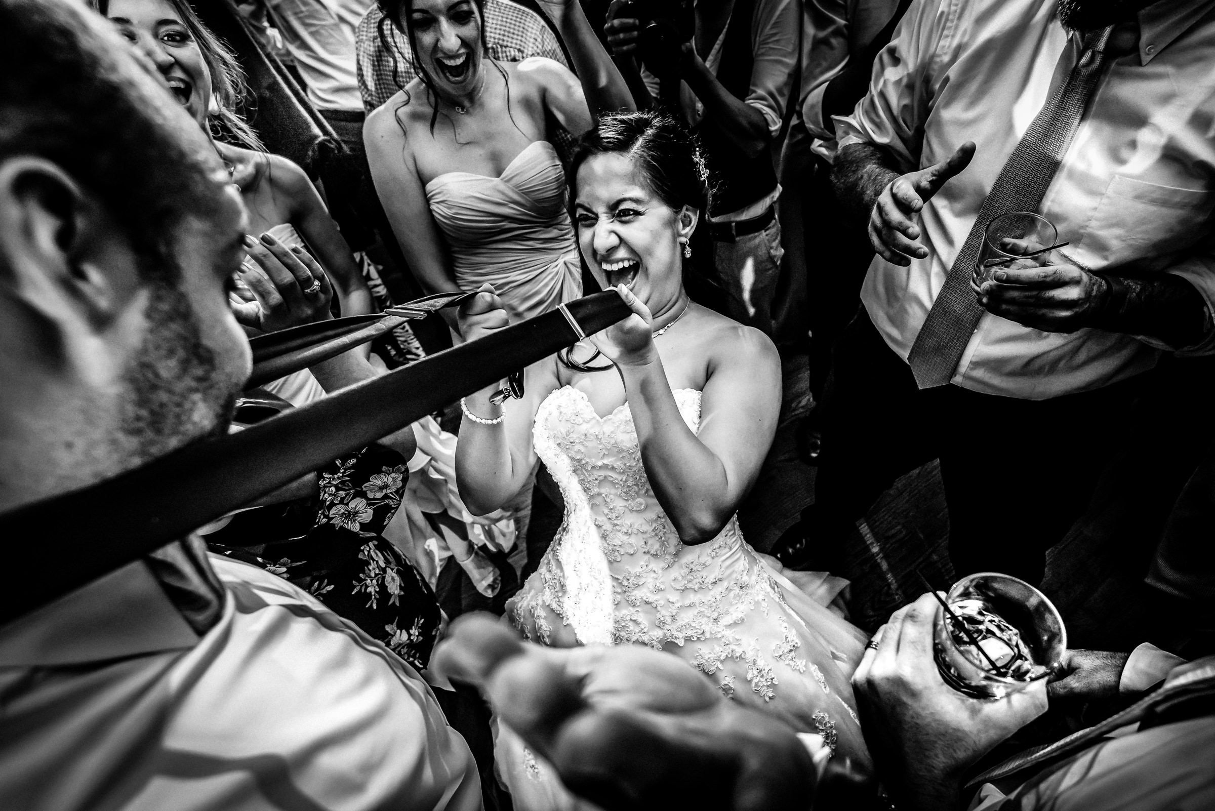 Award-winner, party bride shimmying up to groom, photo by Nick & Kelly Photography